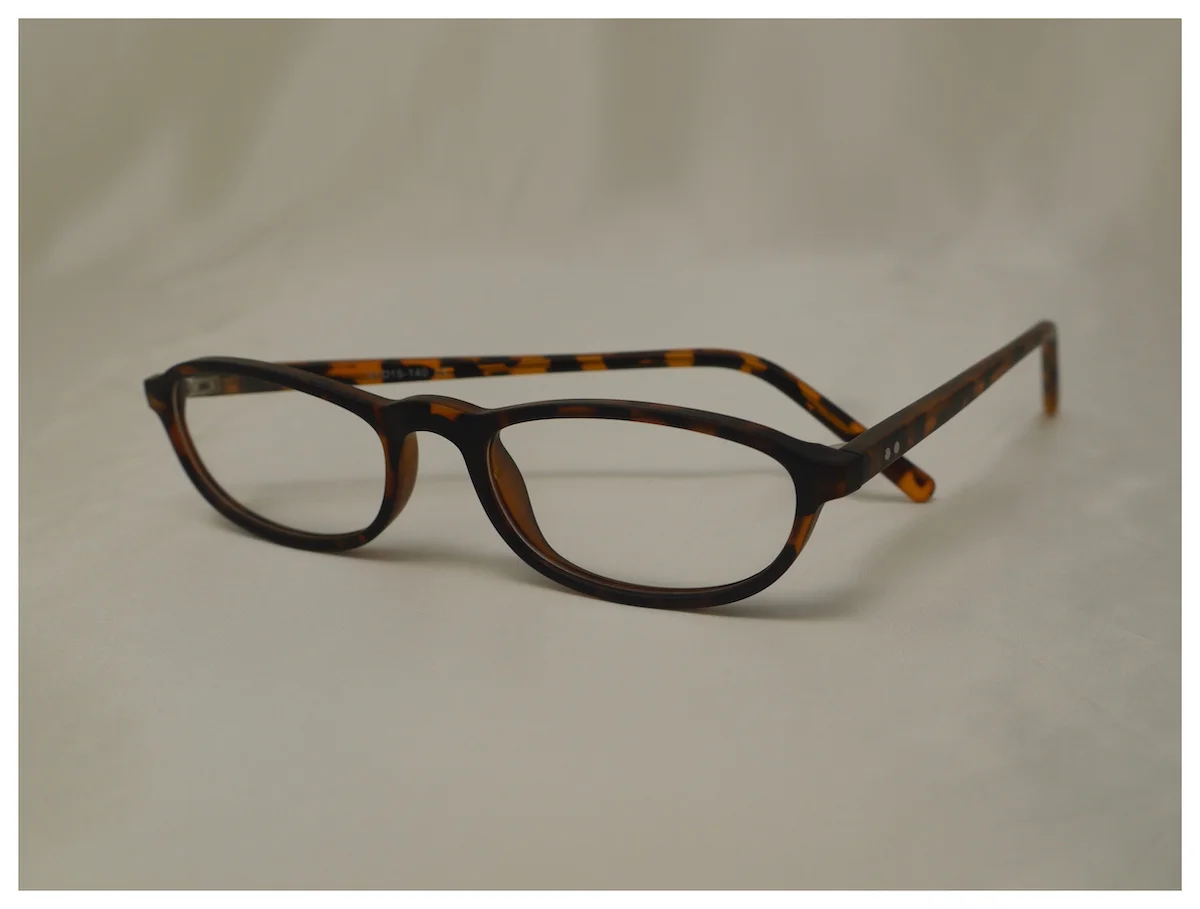 plastic pair of half-eye reading glasses