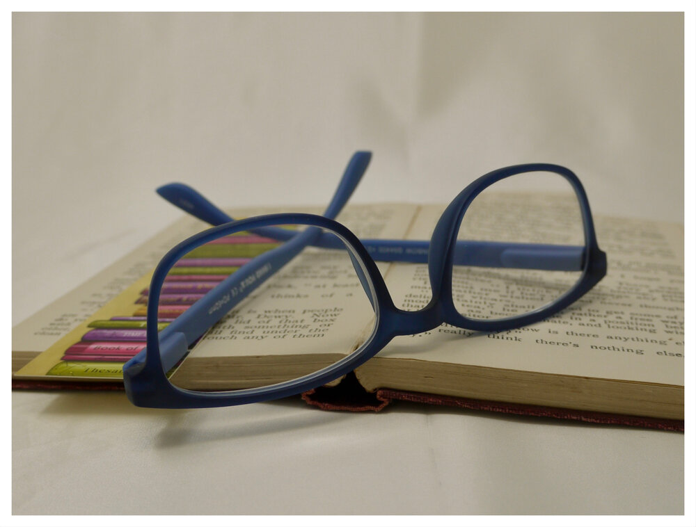 pair of blue plastic reading glasses