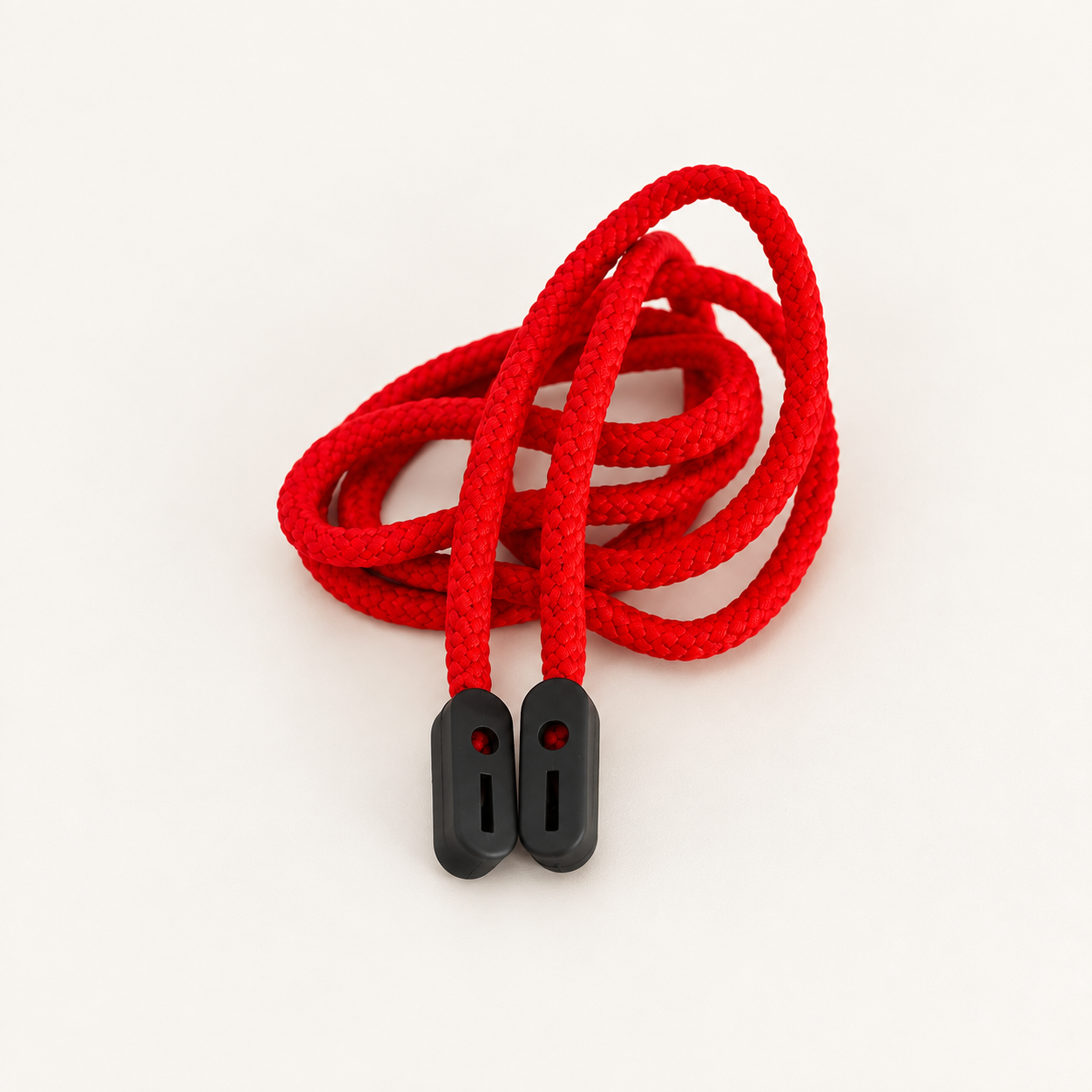 Red braided glasses cord in loose loops with two black rubber grip ends