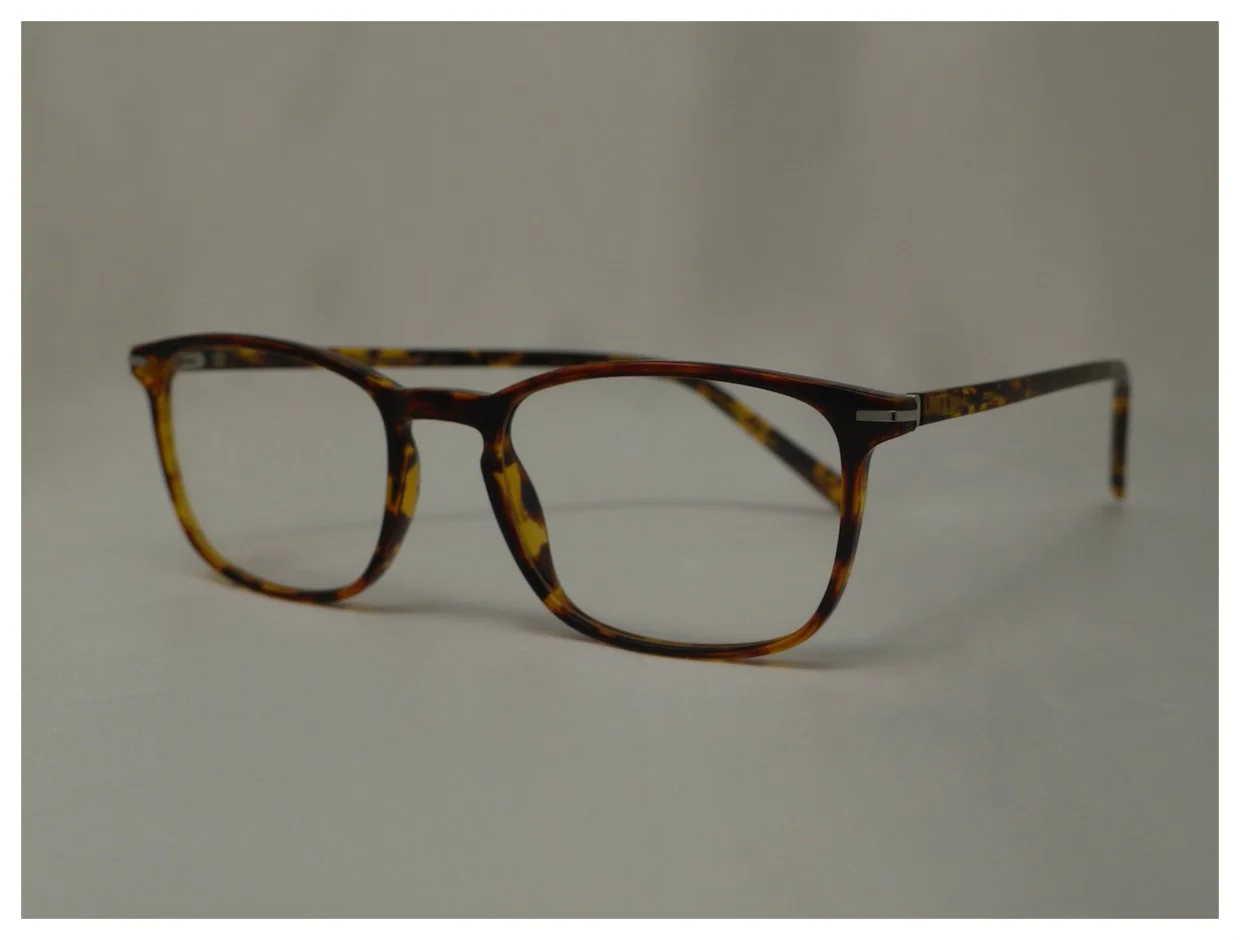 Angled view of classic tortoiseshell plastic reading glasses frames showing hinge detail