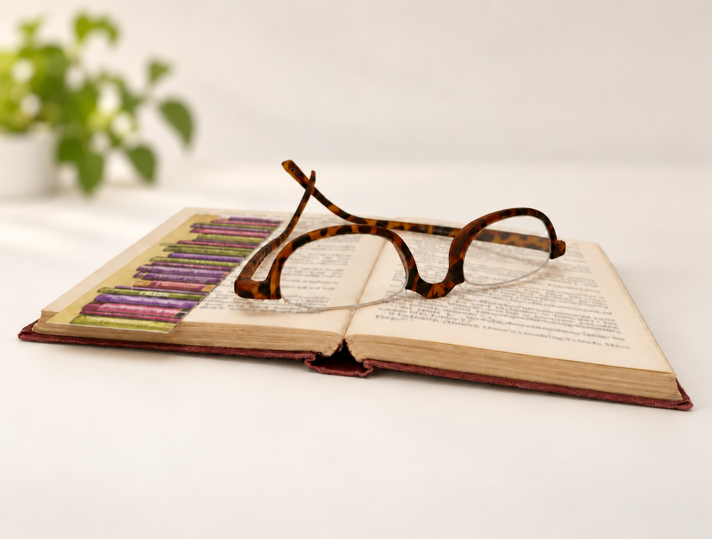 Kensington tortoiseshell half-eye reading glasses resting on an open book