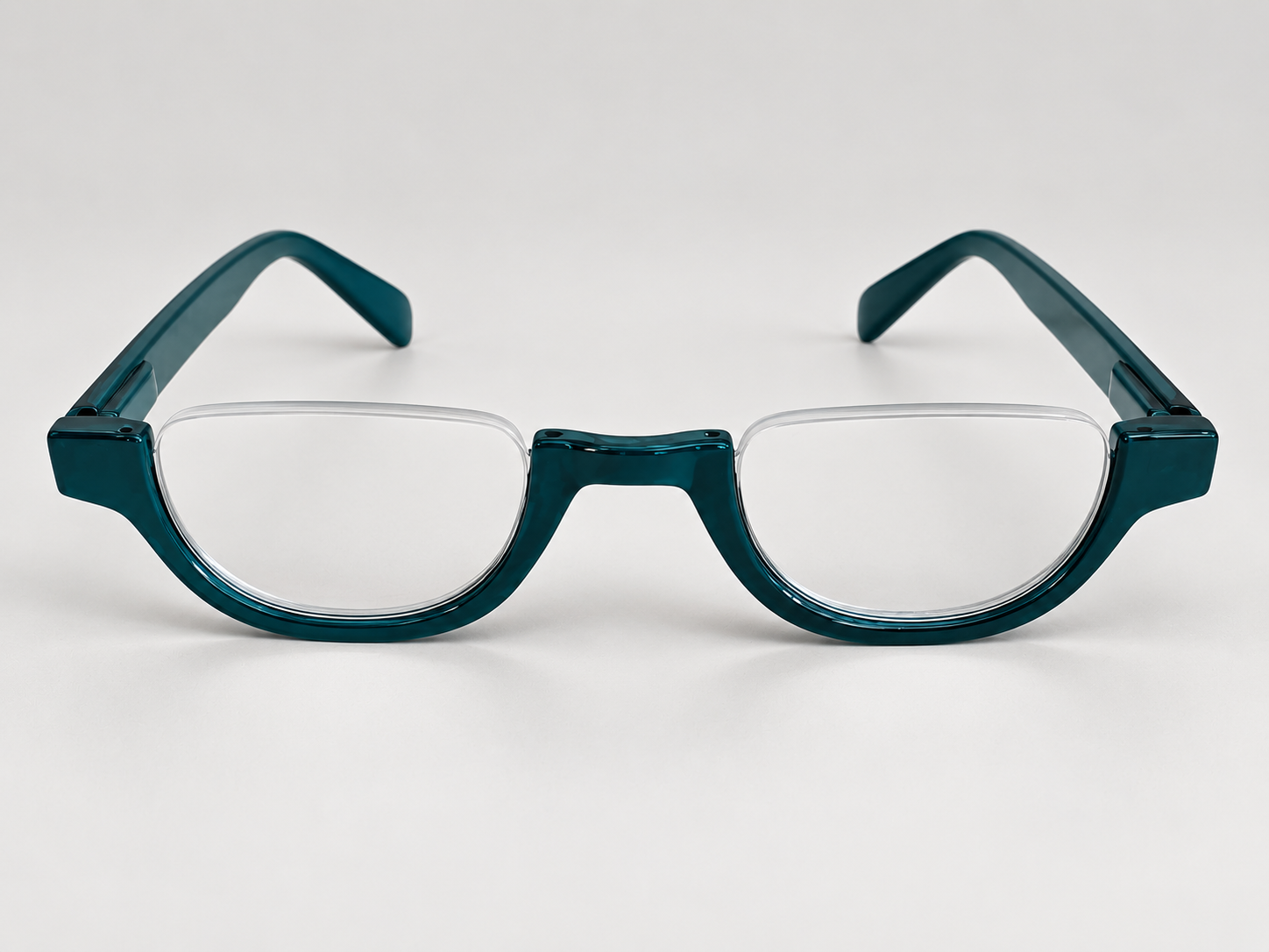 Front view of Cove teal half-eye reading glasses with open-top lenses and a glossy teal bridge and lower rims