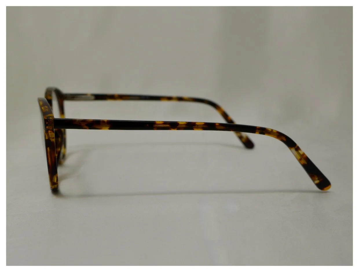 Side profile view showing the slim tortoiseshell temple arms of model B-AC13A