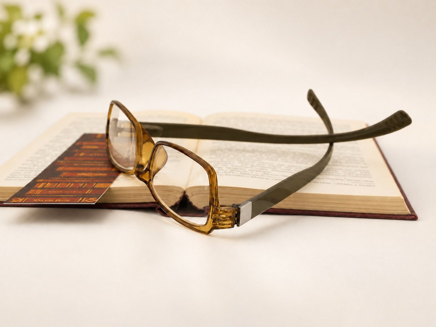 Honey SpecNecs C-2609 long-arm reading glasses resting on an open book