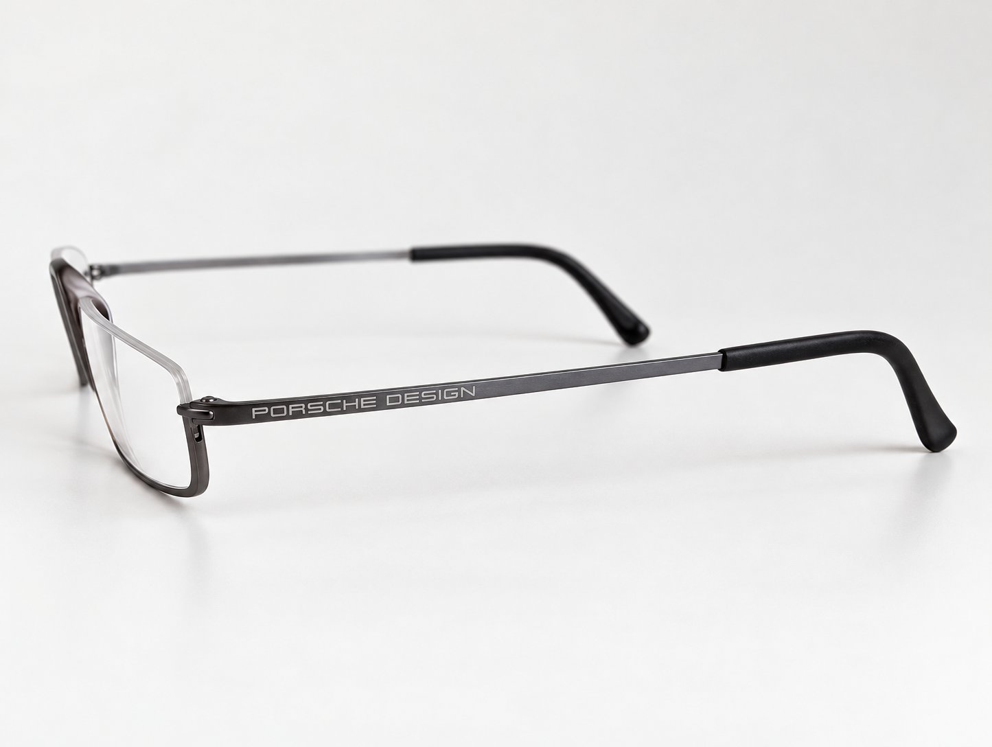 Side view of Porsche Design P8002-C reading glasses showing the branded gunmetal arm and black tip