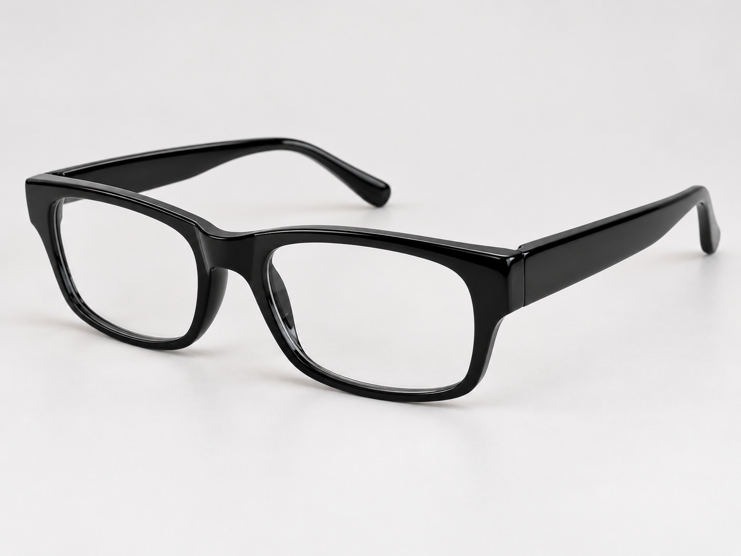 Rowan black rectangular reading glasses viewed at an angle, showing the glossy plastic frame and arms