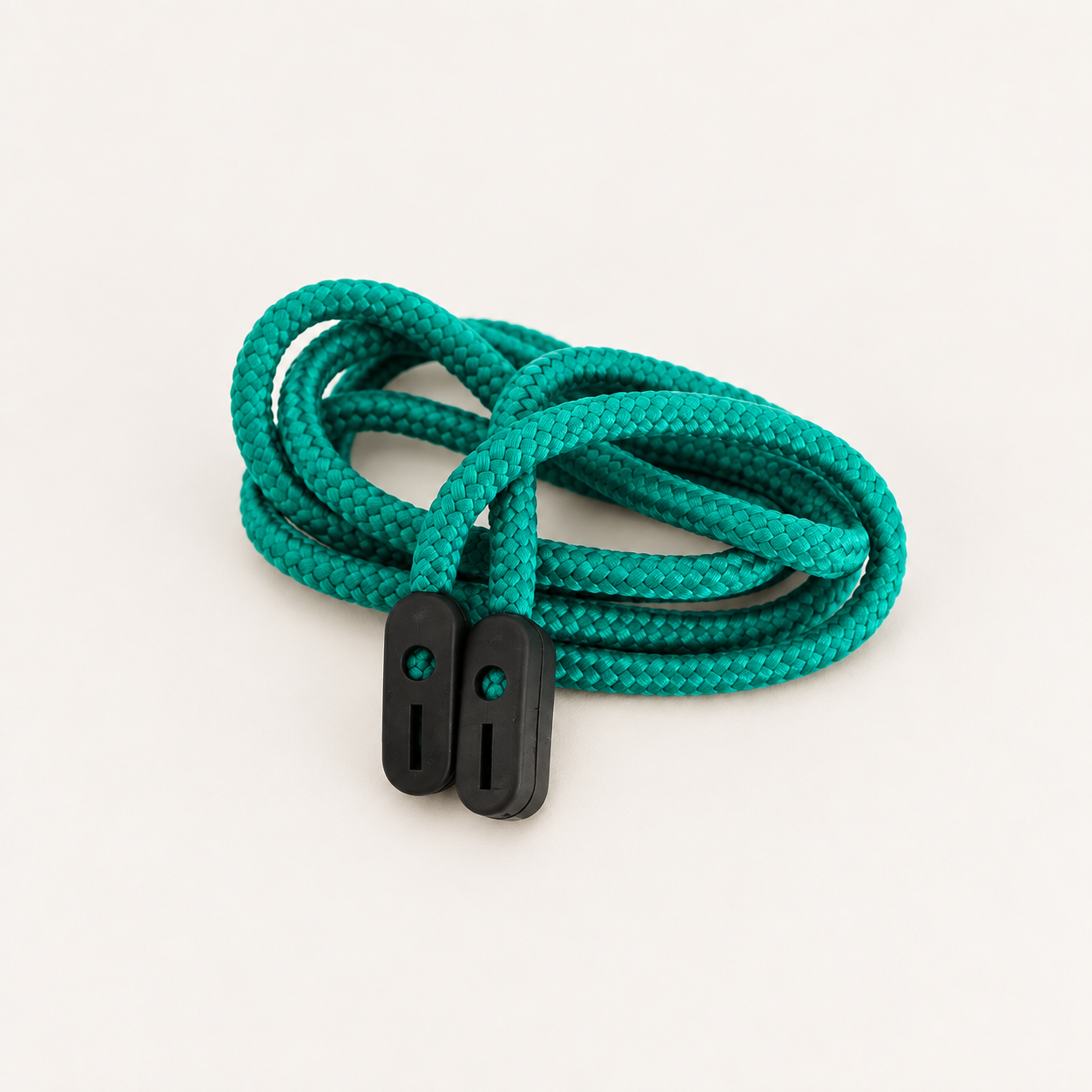 Jade green braided glasses cord loosely coiled with two black rubber grip ends