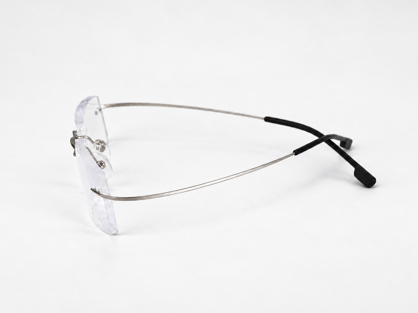 Side view of FlexiSpex 9946 glasses showing the slim silver temples and black earpieces