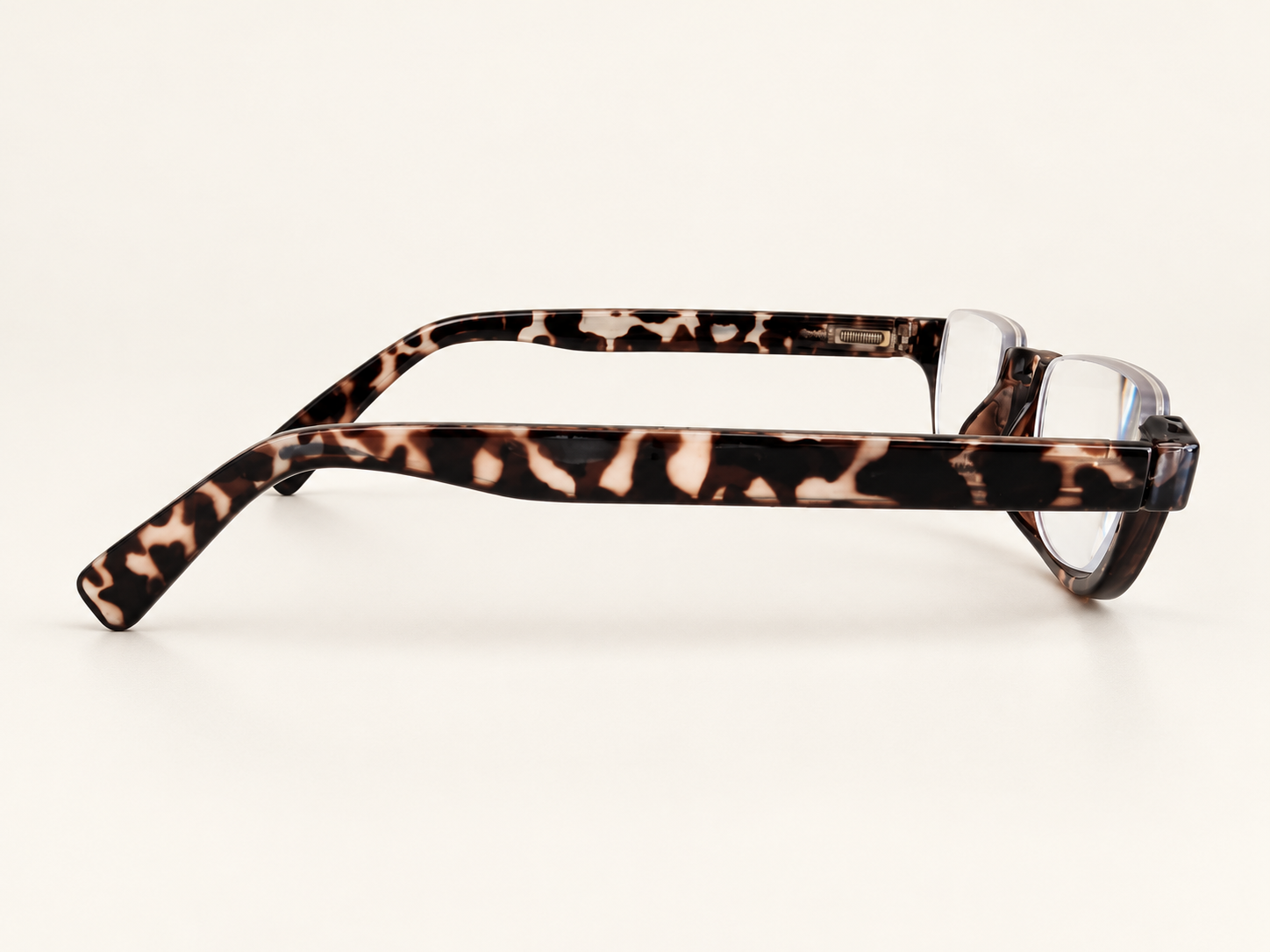 Side view of Cove tortoiseshell half-eye reading glasses showing the broad patterned arm and curved tip