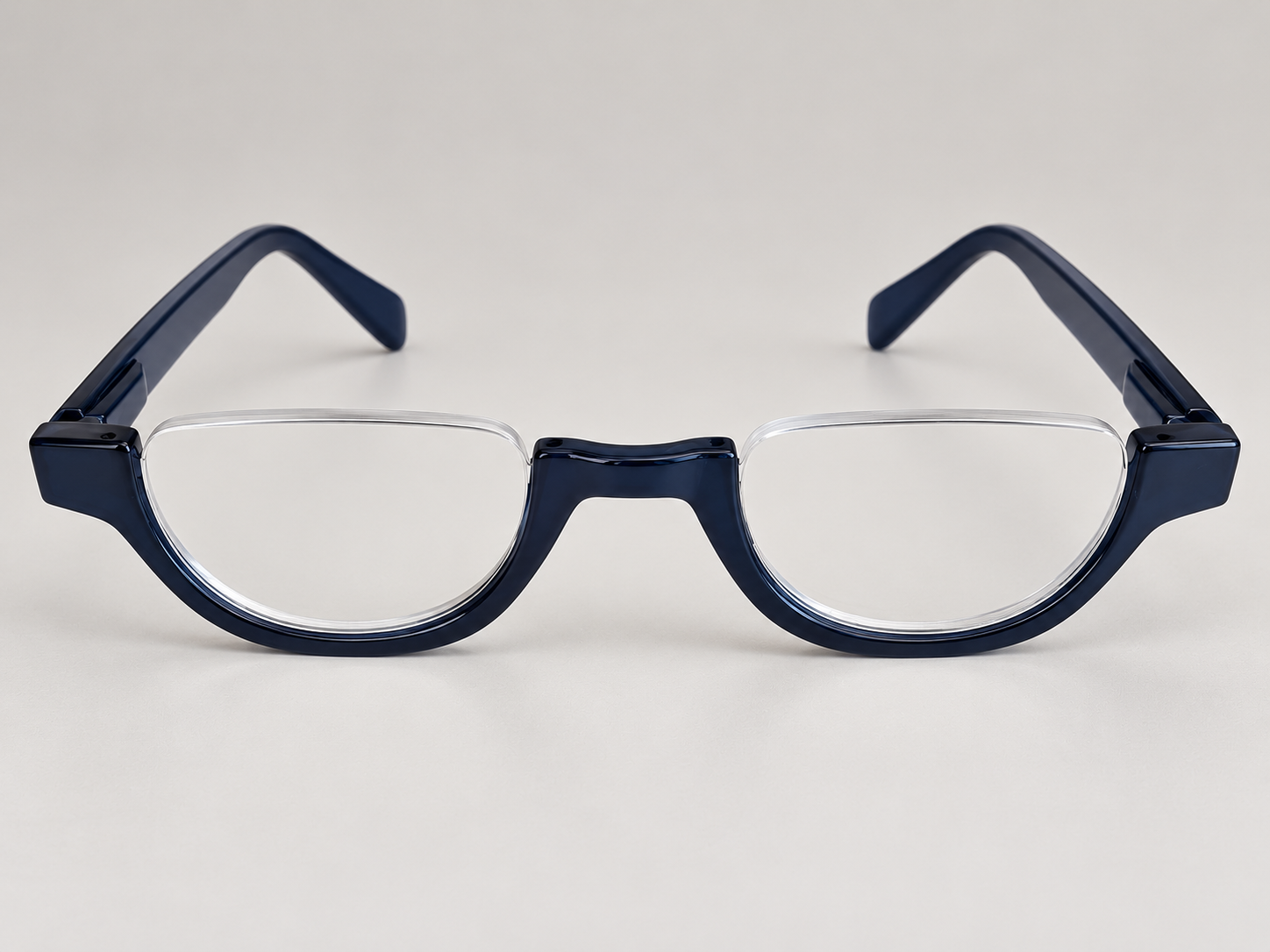 Front view of Cove blue half-eye reading glasses with open-top lenses and a glossy navy blue bridge and lower rims