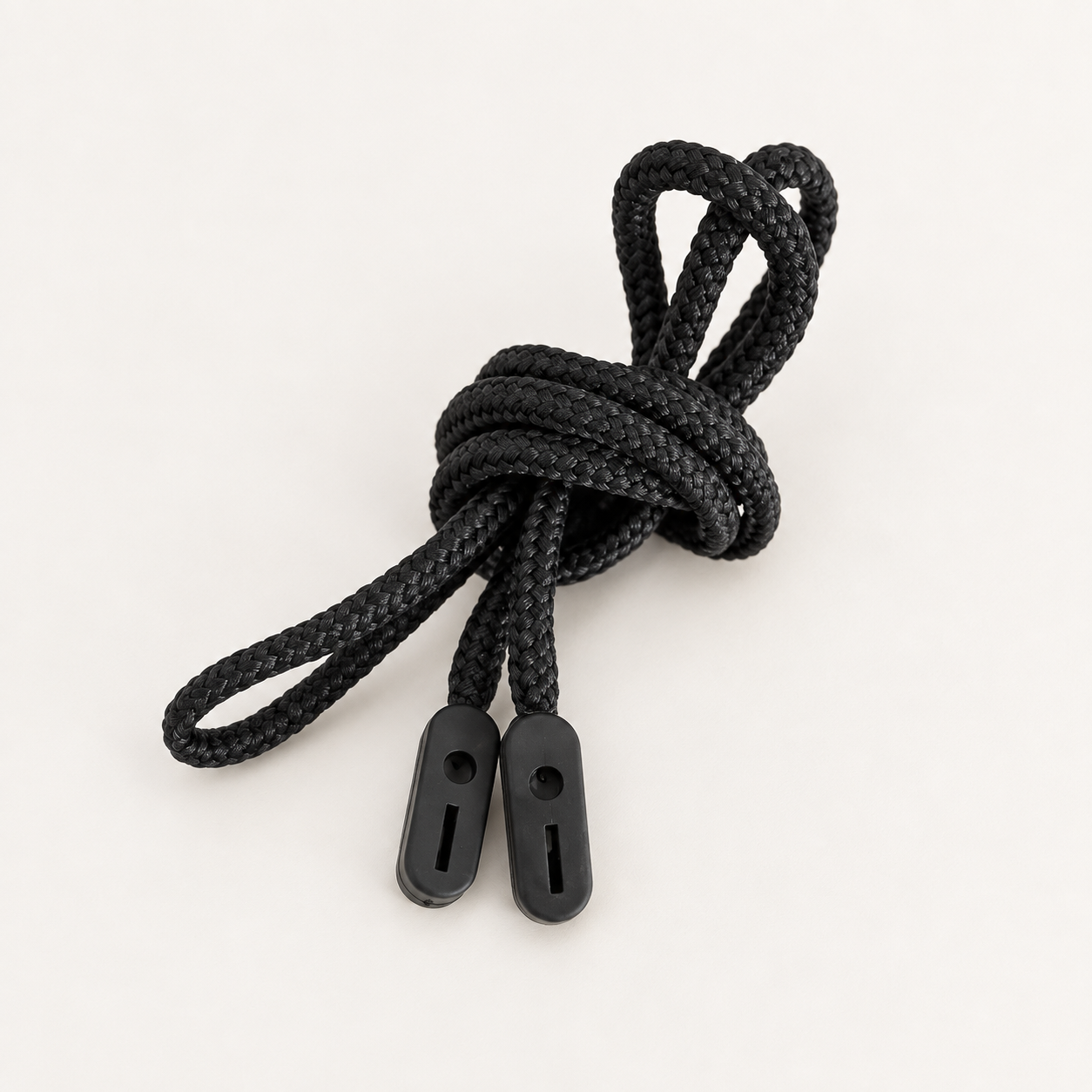 Black braided glasses cord loosely coiled with two rubber grip ends