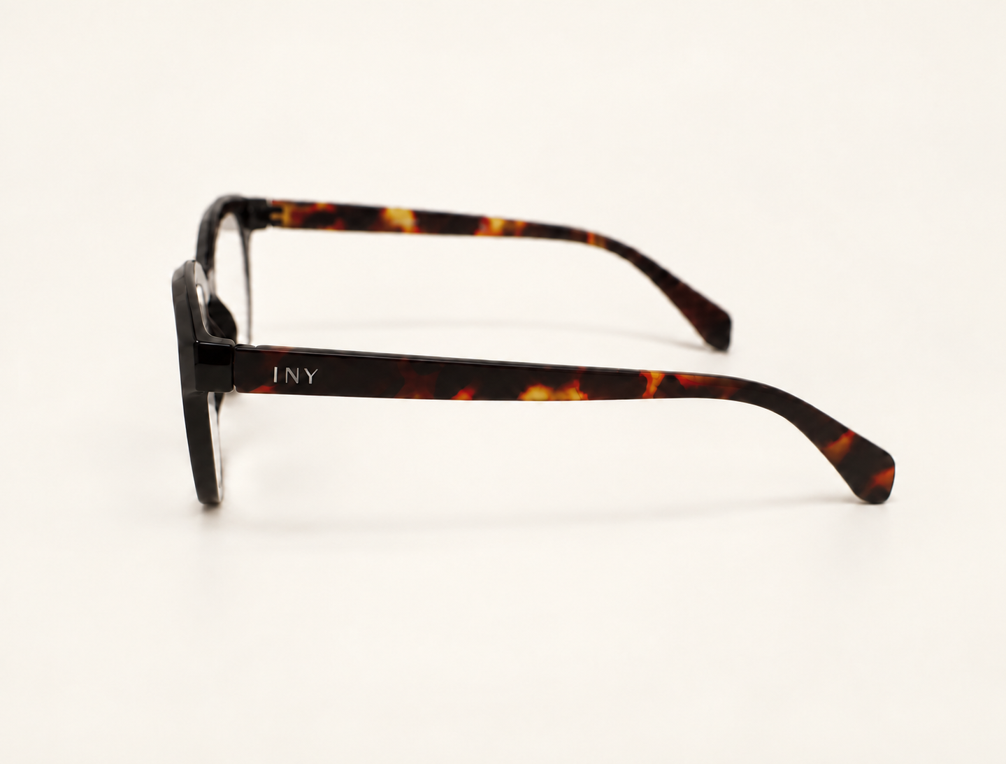 Side view of Jackie reading glasses showing the tortoiseshell temple and INY logo