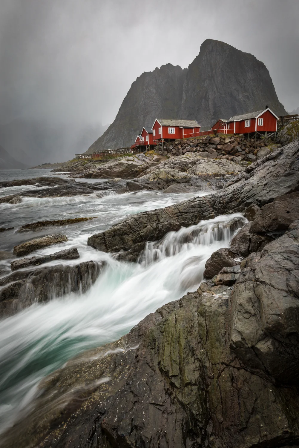 This image is taken on one of the worst days I’ve seen on the Lofoten this far. It took me over an hour and 6 images to get one I was happy about. Raindrops and the right timing, made this really hard. I had packed my camera a couple of times as the rain worsened. I was soaking wet, even my waterproofs seemed to be at a point of giving up. Rain was literally dripping from my camera, but I am stoked about the final result! Tamron SP 15-30 | 19 mm | f/18 | 1/3 sec | ISO 100.