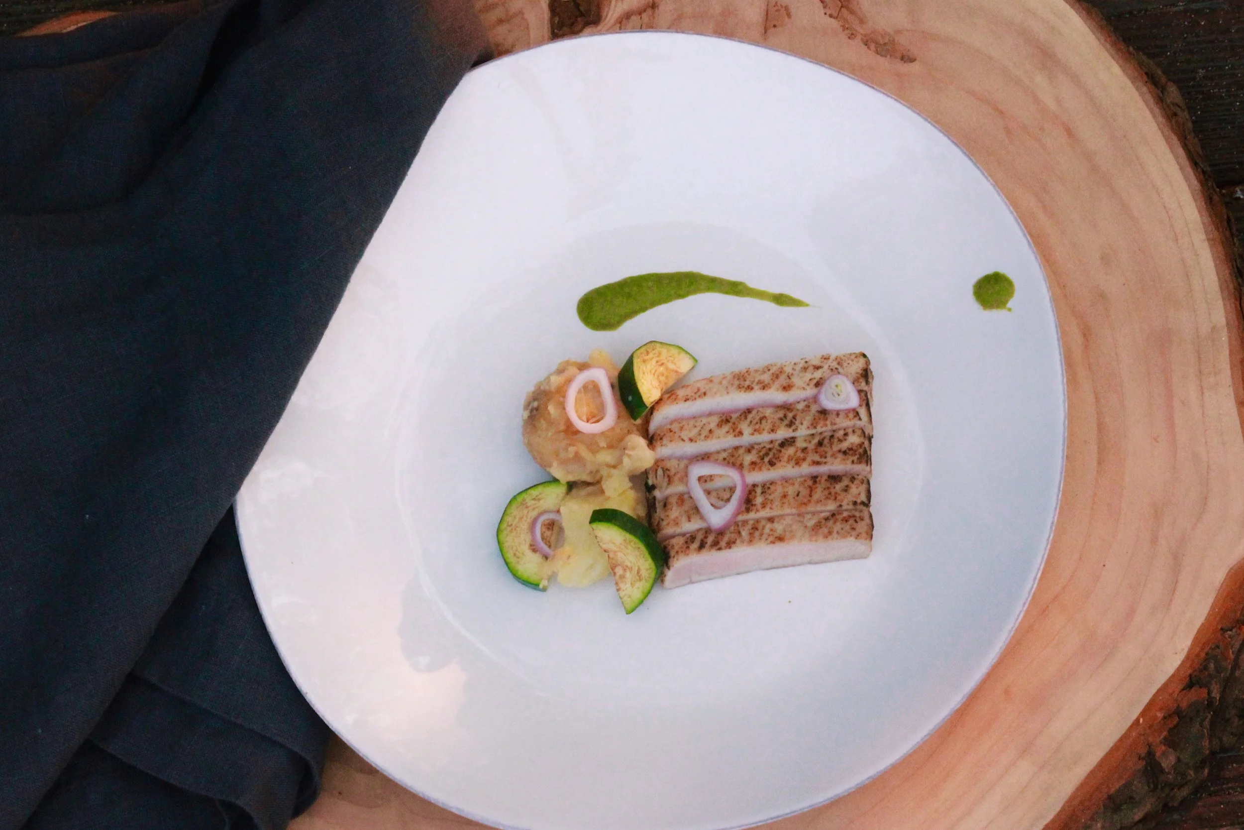 Seared pork loin with smashed potatoes, pickled shallot, zucchini and chimichurri