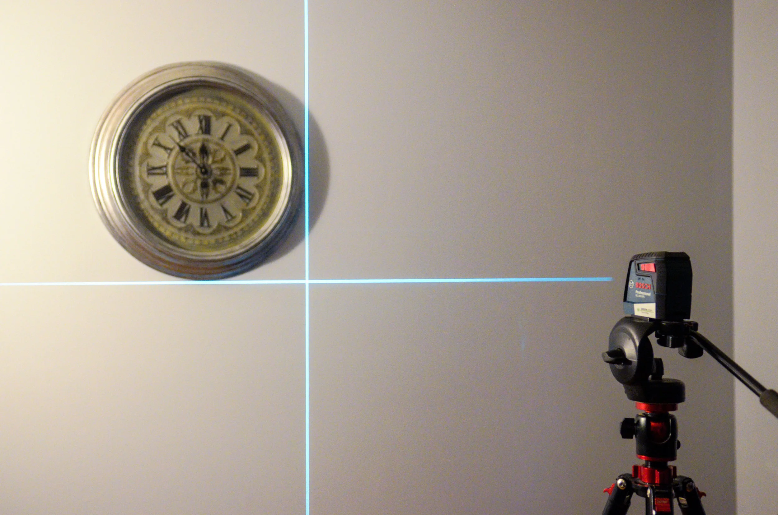 The Bosch 40-ft. cross-line level projected on a light blue wall.