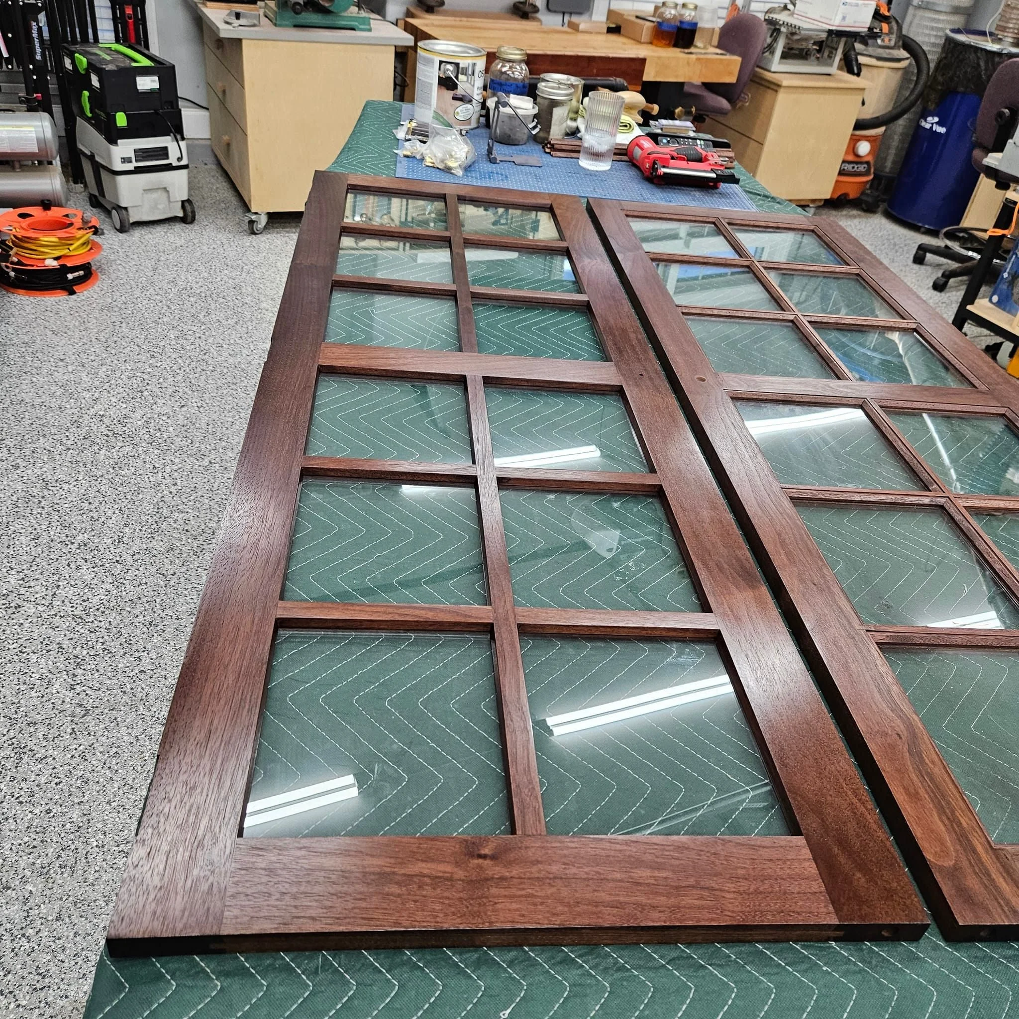 Set the window panes for the French doors on the china cabinet. I used mitered glazing stops and 23 gauge pin nails to set the glass into the muntin bars. My mitering setup consists of a saw hook, pull saw, shooting board, and miter plane. And just m