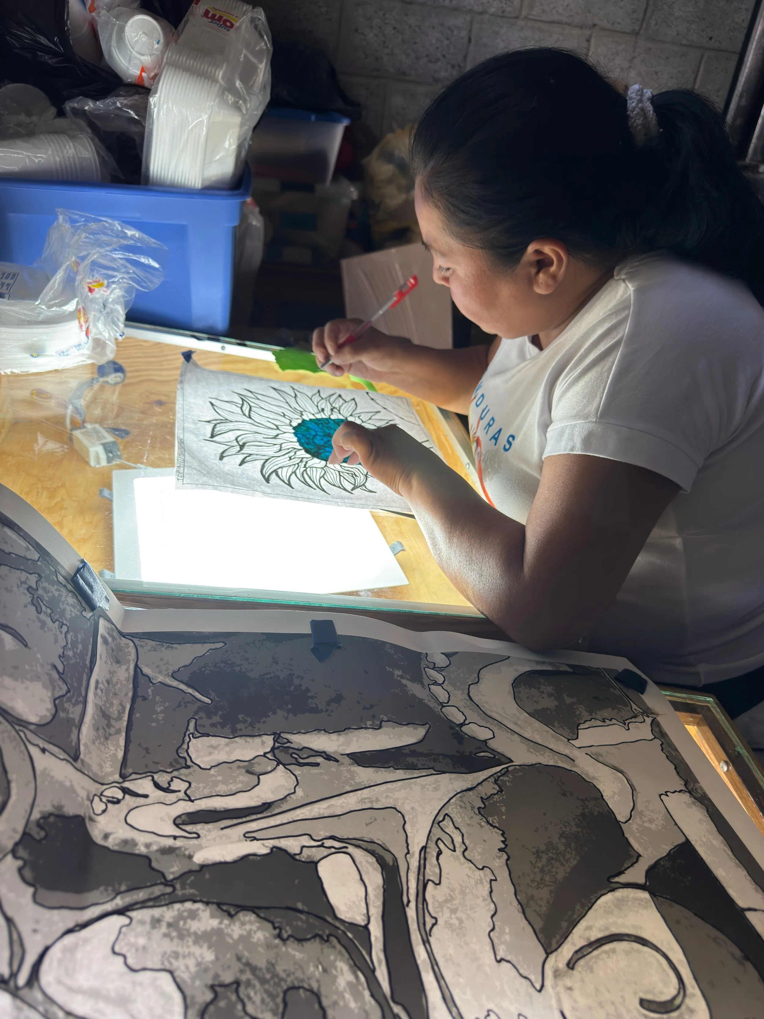 Honduran Woman tracing stencil on lighttable