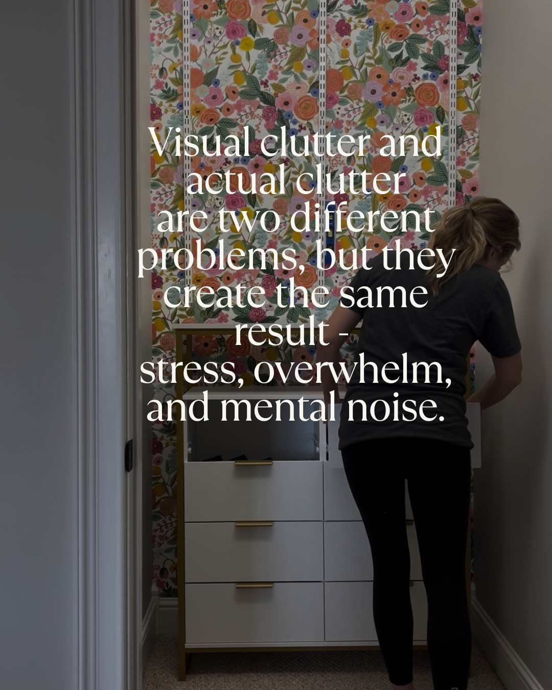 Woman organizing drawers in a colorful floral room, illustrating visual clutter vs actual clutter and its impact on stress and overwhelm