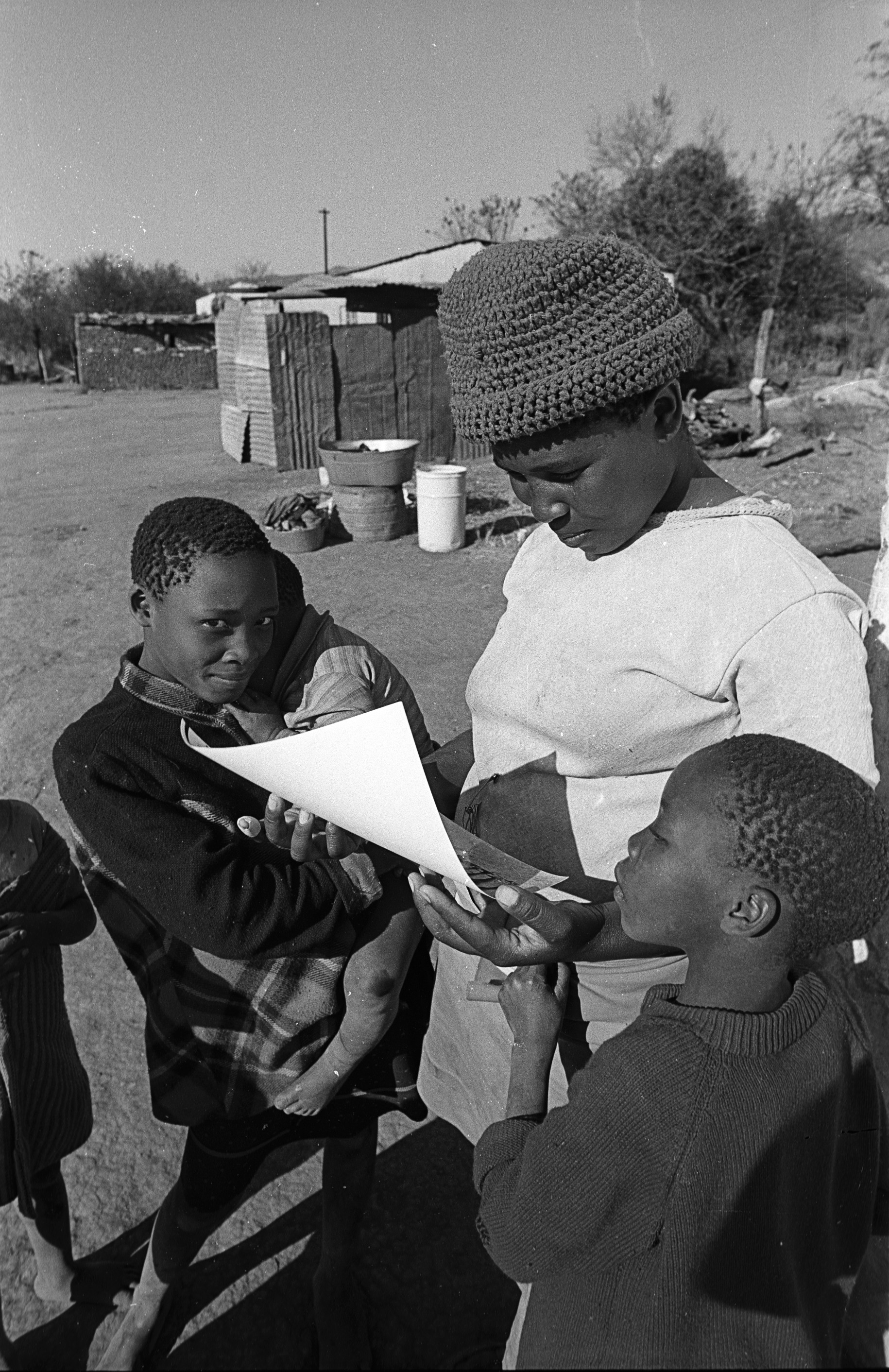 I would take pictures of the people and the the following week after I have developed and printed them I would return and give them a print or two of themselves. 