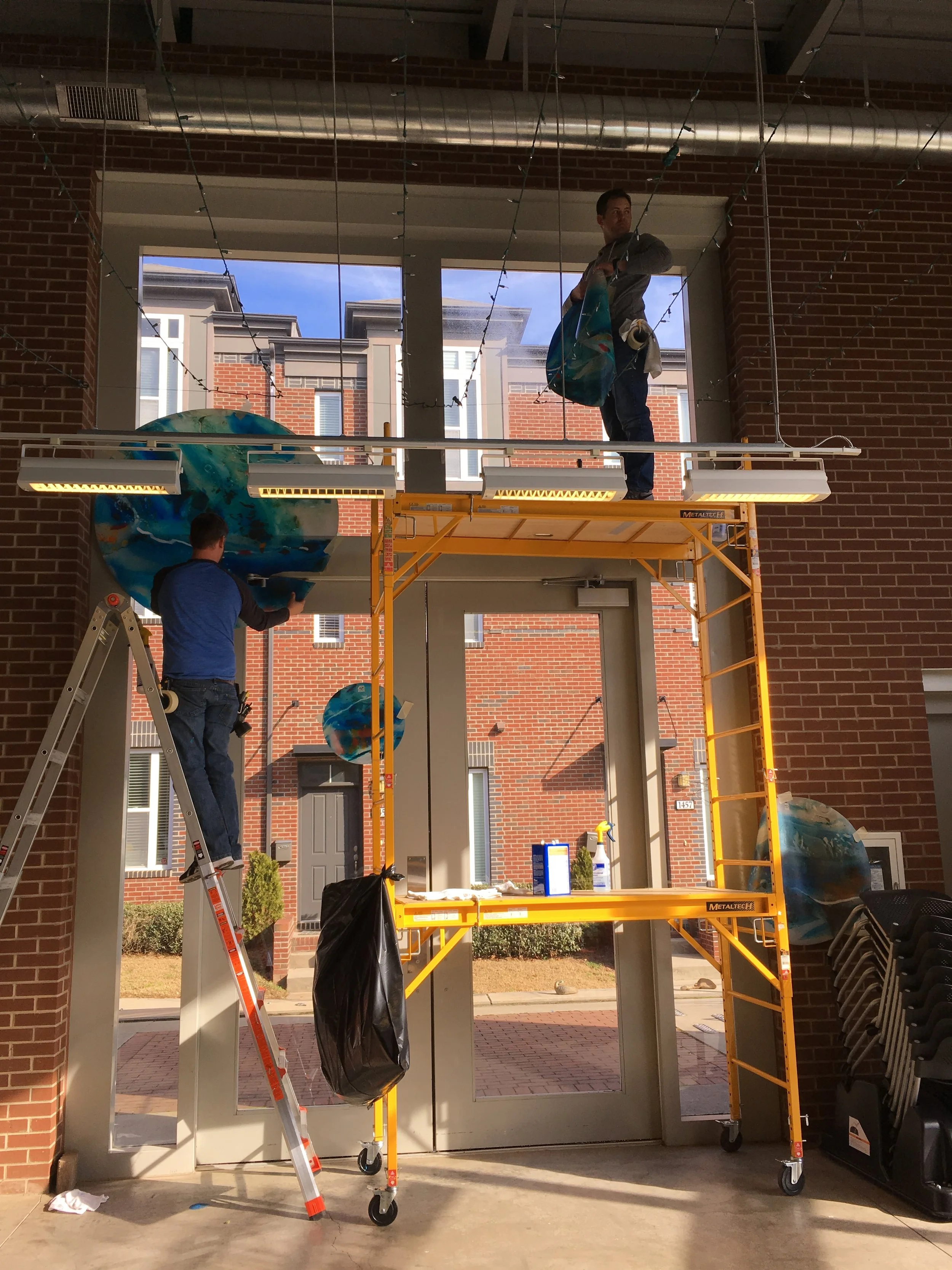 After placement, they cut & adhered one section at a time to glass.