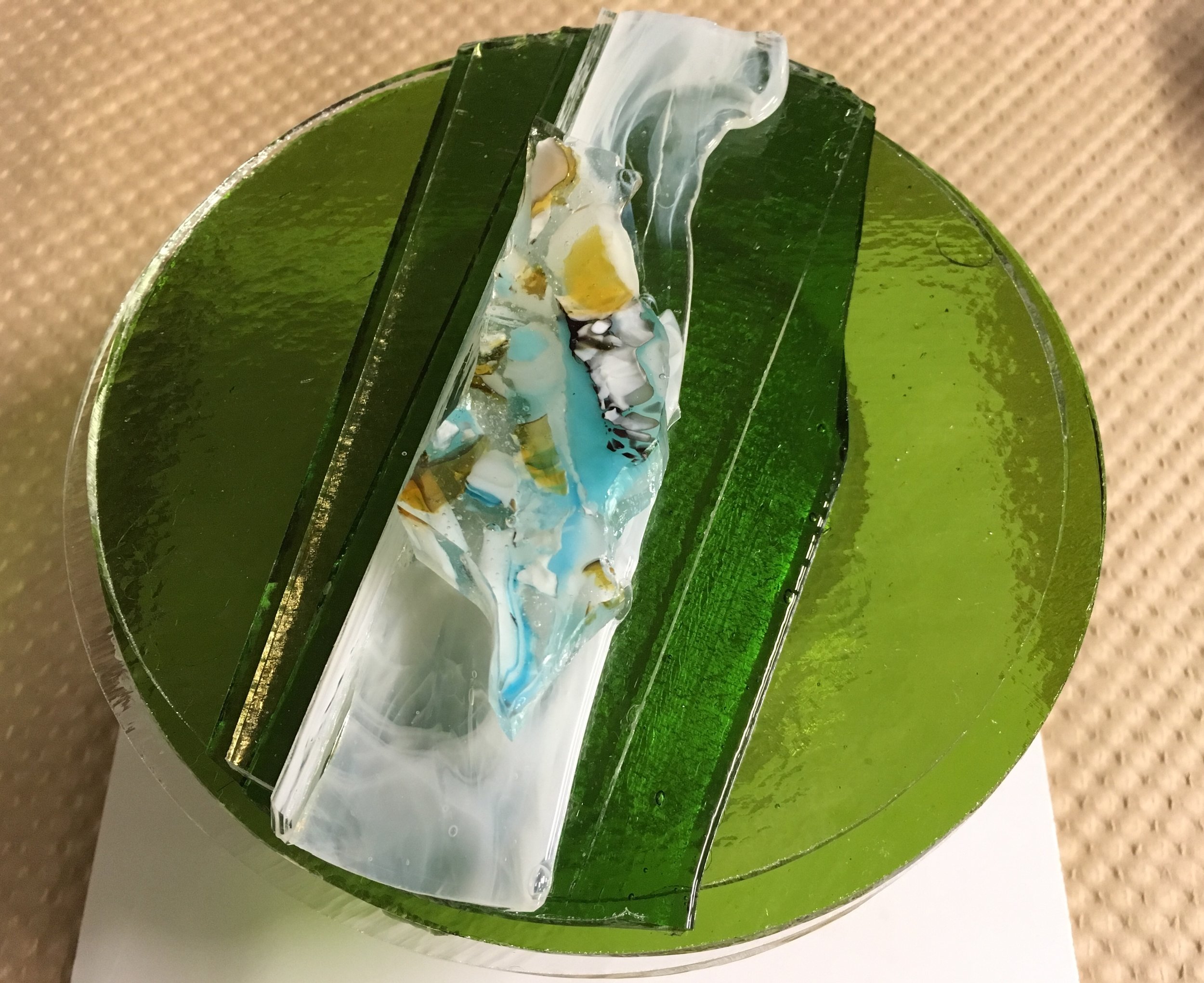 This is one way I make my glass water rounds — before I add a lot more glass to top. (Chunk on very top has been pre-fired several times.)