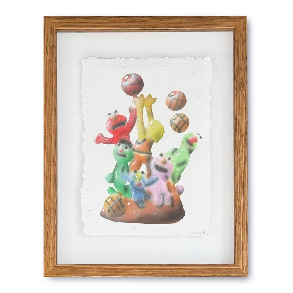Colorful clay figurines of various creatures and balls inside a wooden frame.