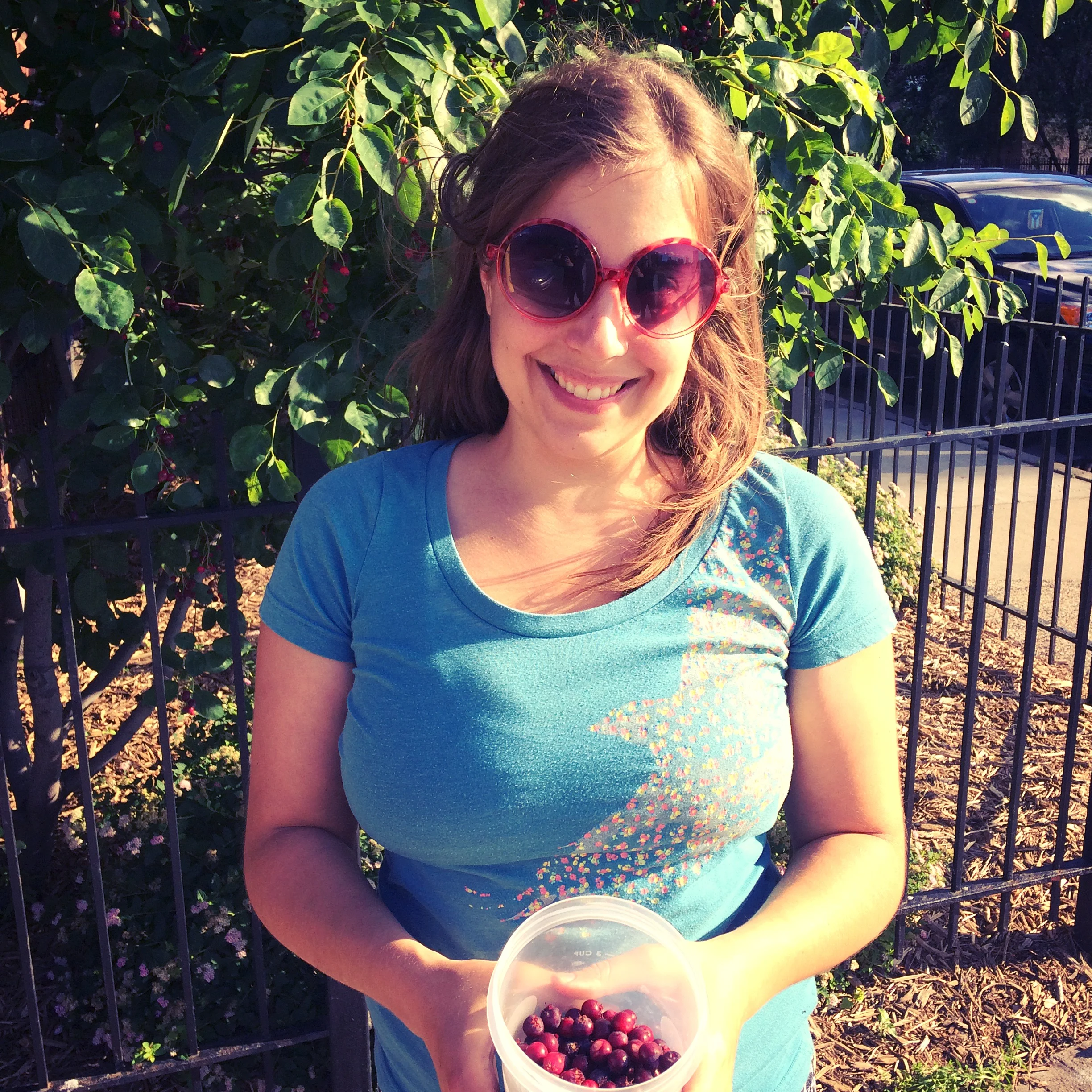 Maria picking juneberries in Minneapolis