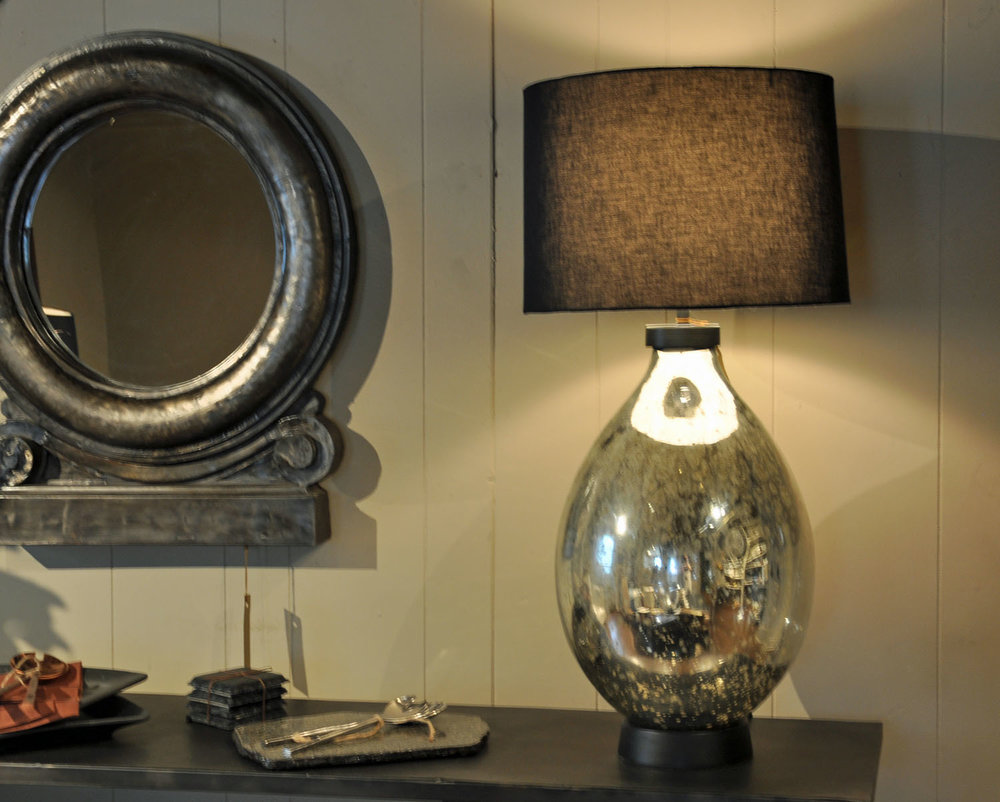   Liezen Collection Lamp  $275 Silver/Mercury   Slate Coasters/Candle Trays  $22 Set of Four   Vaskapu Collection Iron Medallion Mirror  $425 Made in India 