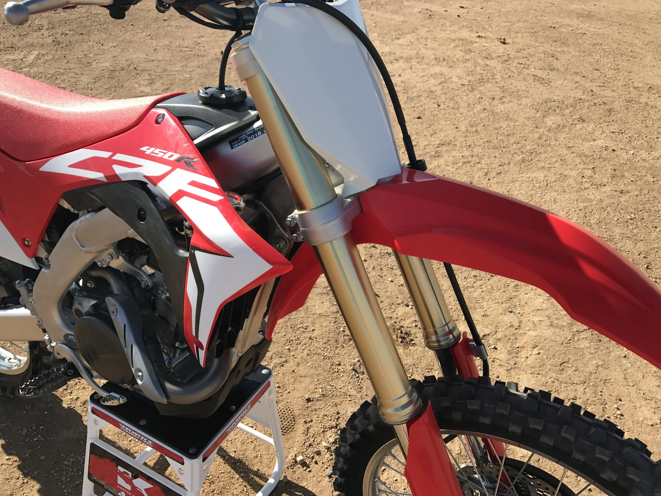 The 49mm Showa spring fork holds up more on de-cel and the bike doesn't have that "pitchy" feel to it.