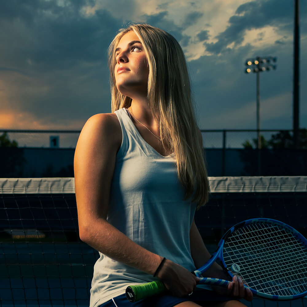 Don Evans Photography in Greensboro NC high school senior womens tennis player poses for her senior picture during her senior picture session with Don Evans Photography.jpg