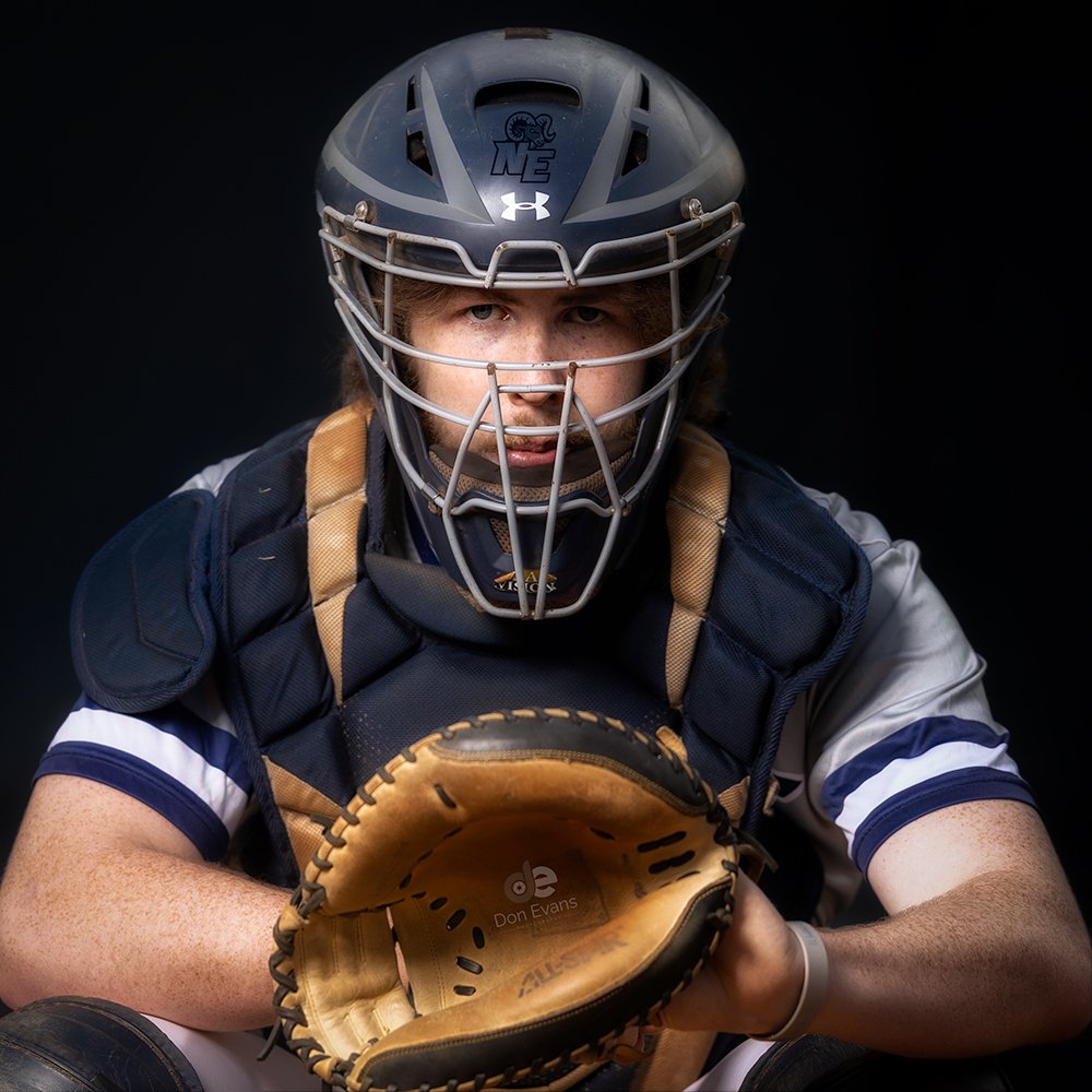 Don Evans Photography in Greensboro picture of a senior baseball catcher in position during his senior pictures photo session