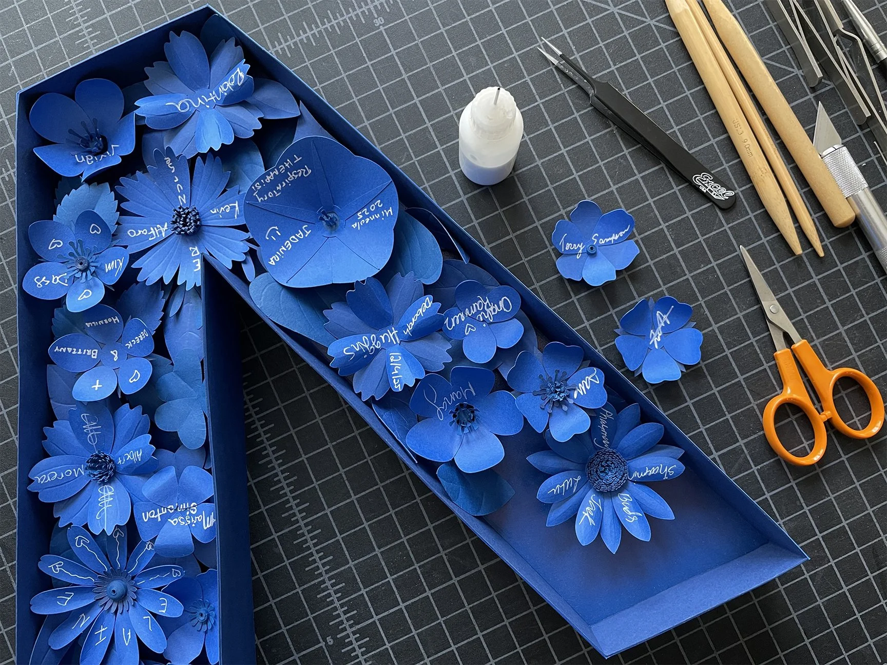 Work in progress – placing sculpted flowers into letters