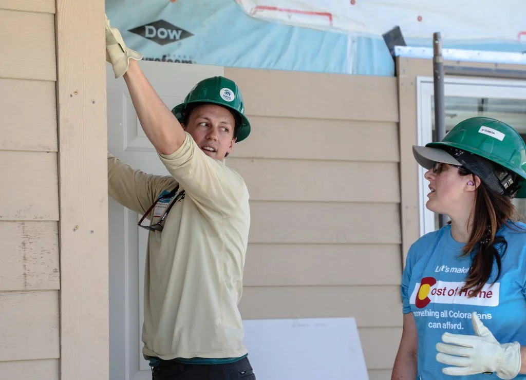 State Rep. Dylan Roberts helps install siding at a Habitat for Humanity home in Gypsum.