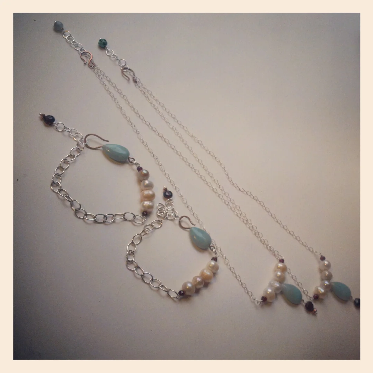 A commissioned series completed in 2012 featuring amazonite, freshwater pearls, pyrite, sterling silver, and copper.