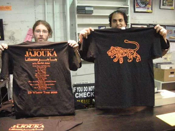 Michael Gassert and Chandra Shukla holding up the MMOJ tshirts at Amoeba Records