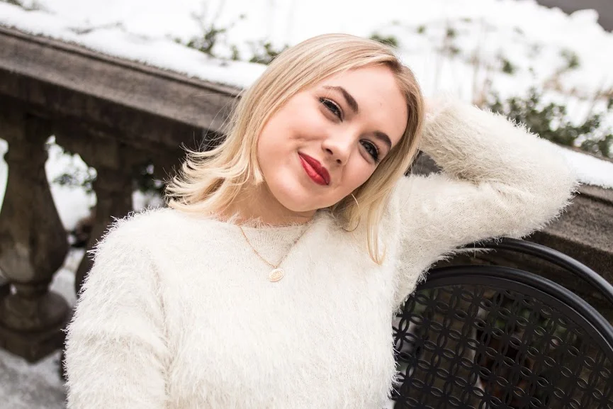 bell bottoms white sweater close up in chair.jpg