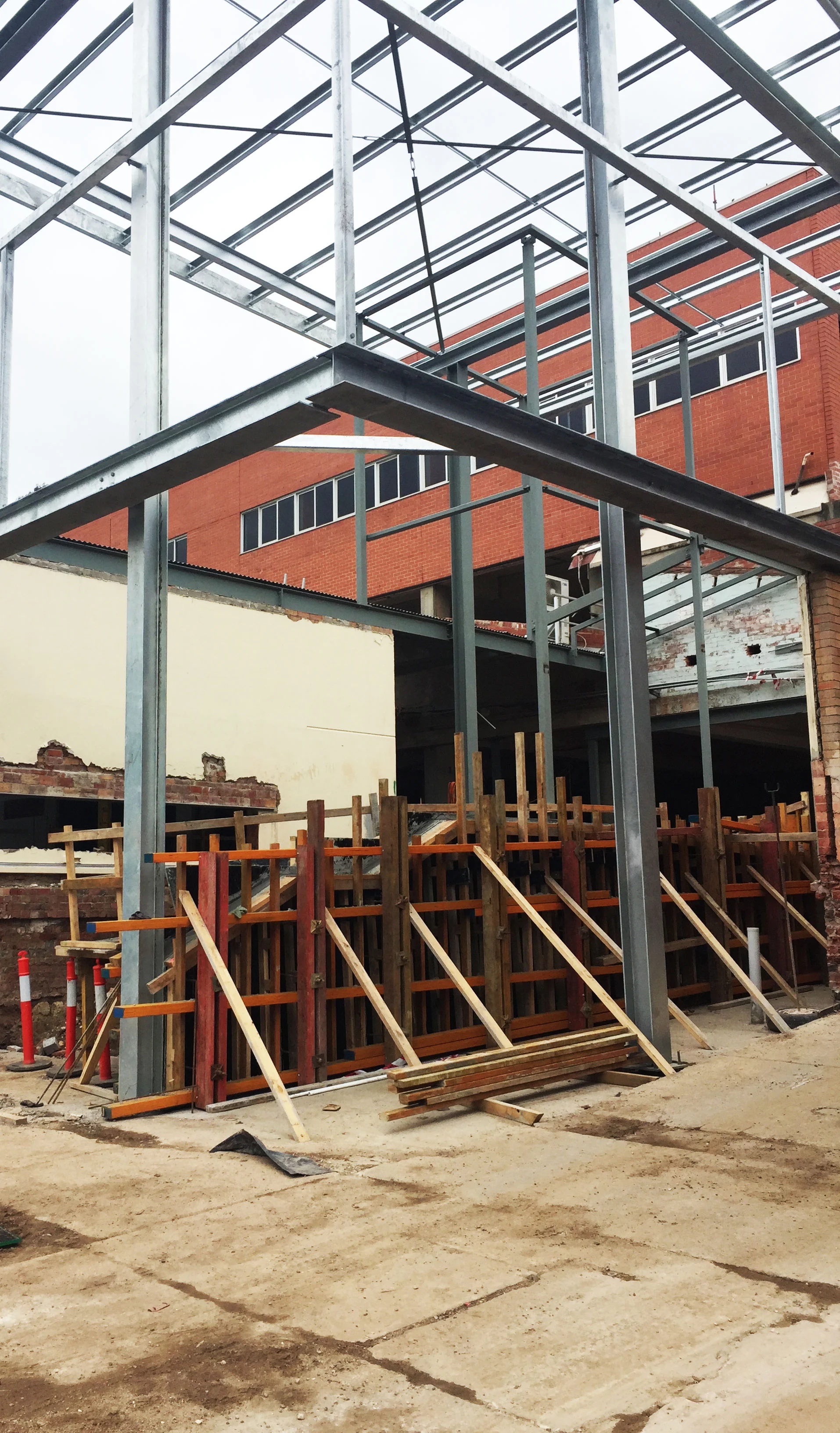 This shot shows the formwork around our folded concrete blade balustrade, which wraps up a ramp at the entry.