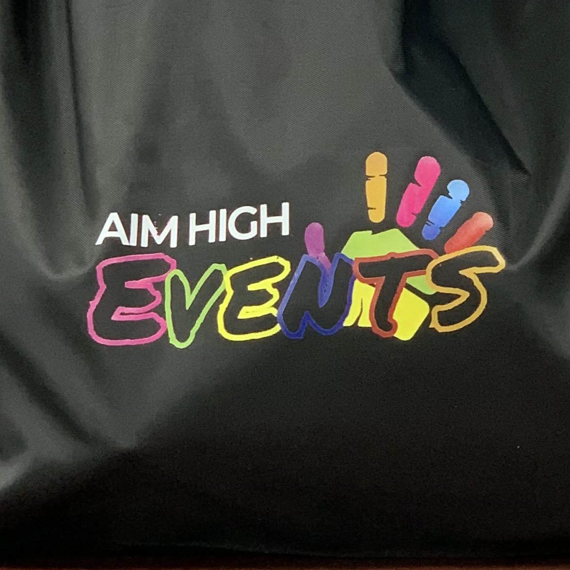 Heat Pressed logo: Aim High Event's logo on a slick polyester material