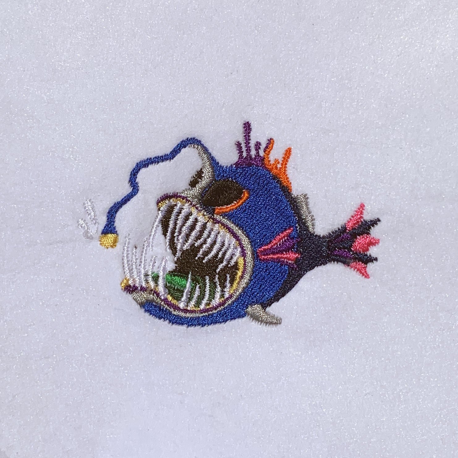 Embroiderd Logo: a very colorful anglerfish