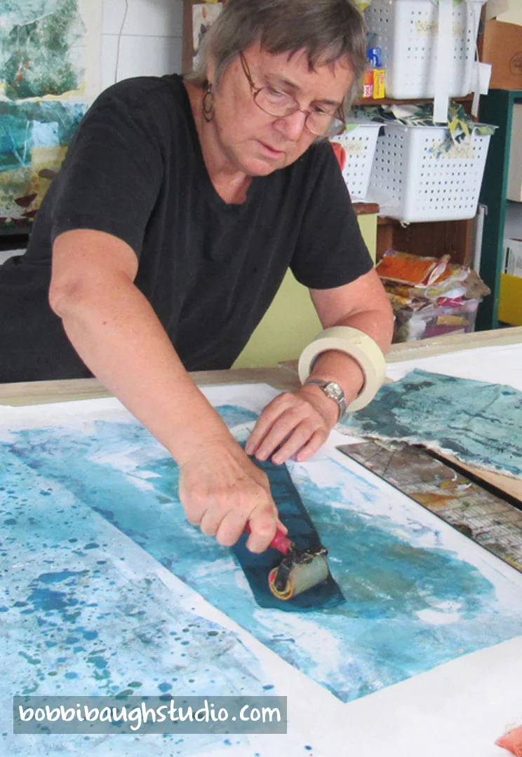 bobbibaughstudio-using-brayer-on-collage-in-studio.jpg