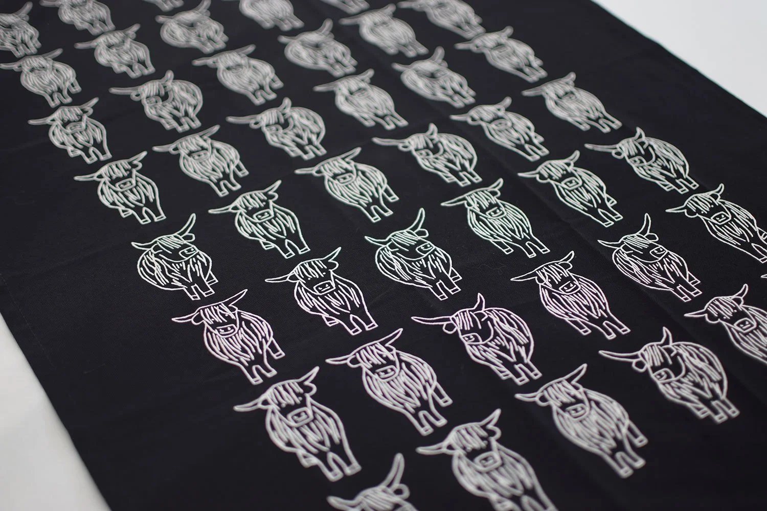 Black and white highland cows organic cotton tea towel by local edinburgh artist Sally Fisher