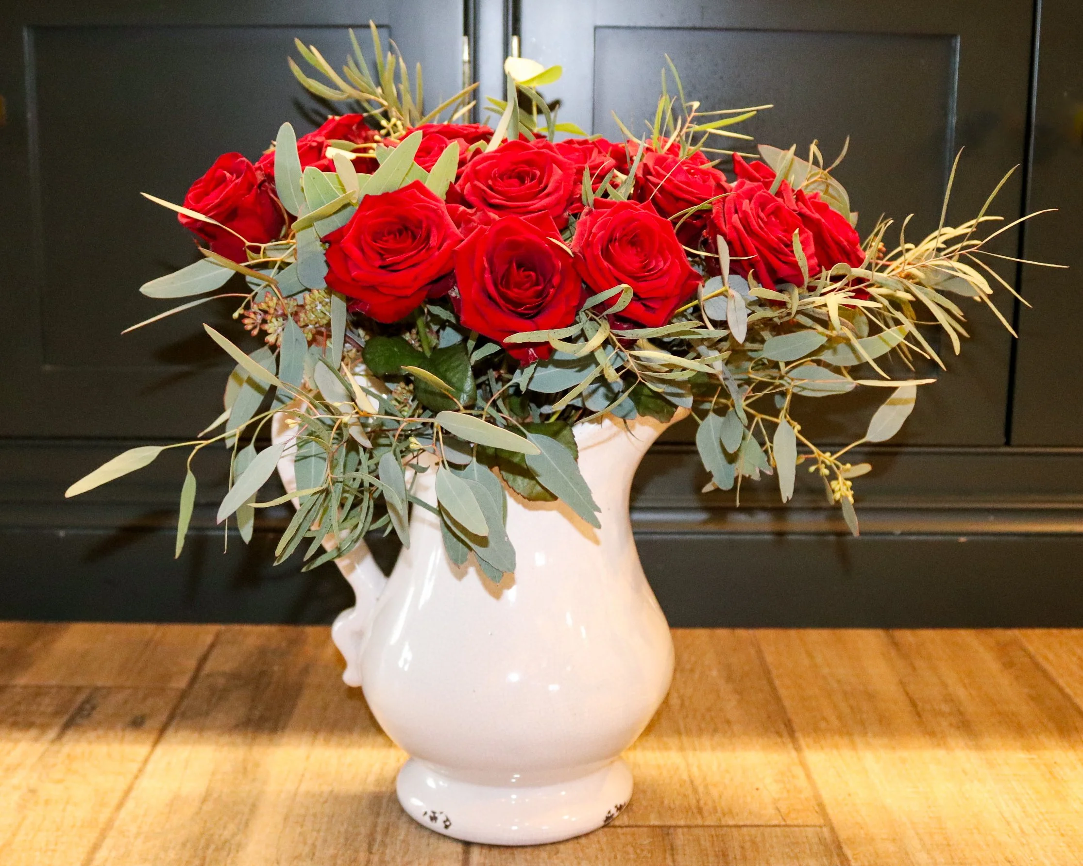A bouquet of Red Naomi Roses with different types of Greenery
