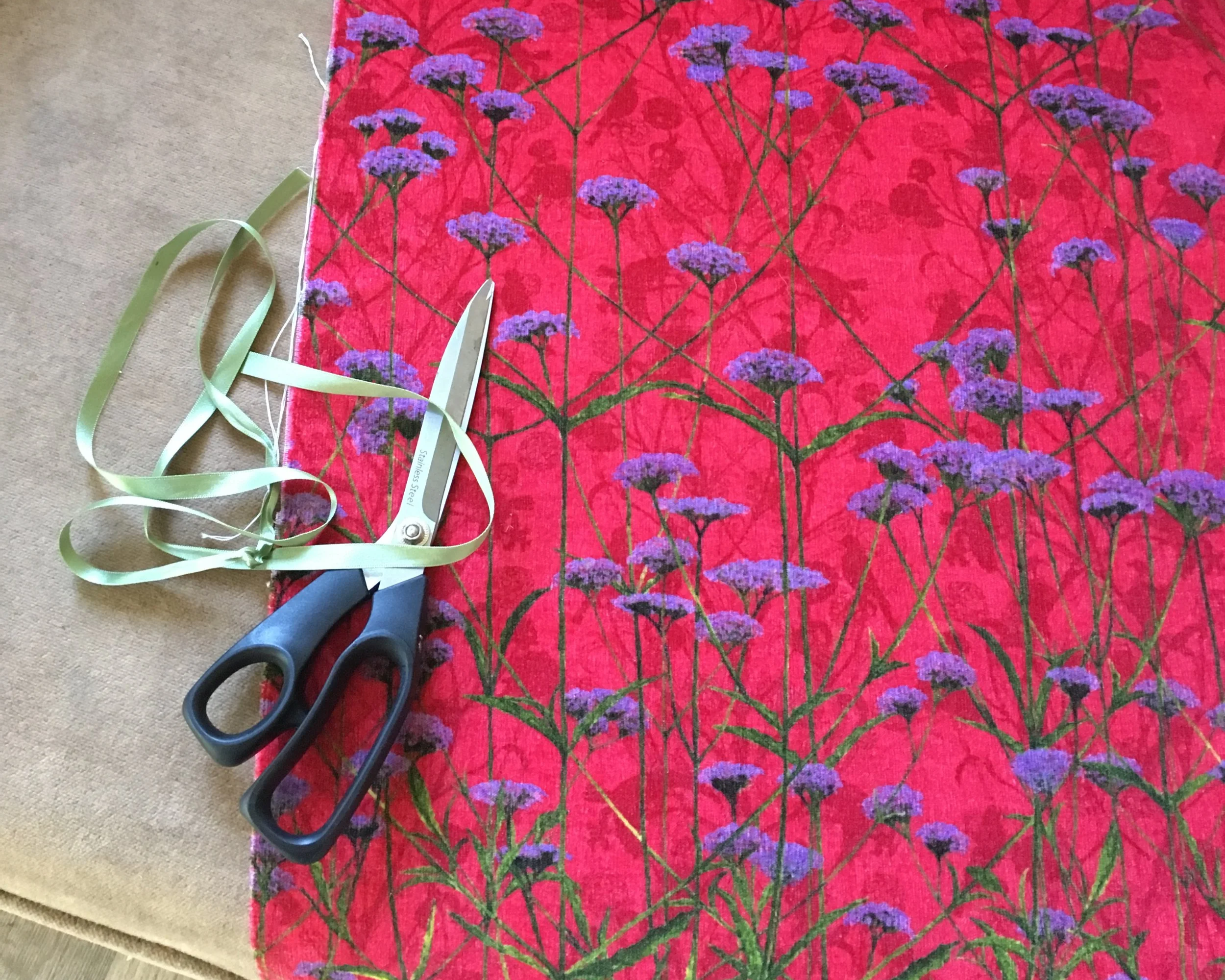 Floral verbena flower design on a soft pink ruby red background printed onto soft cotton velvet in britain
