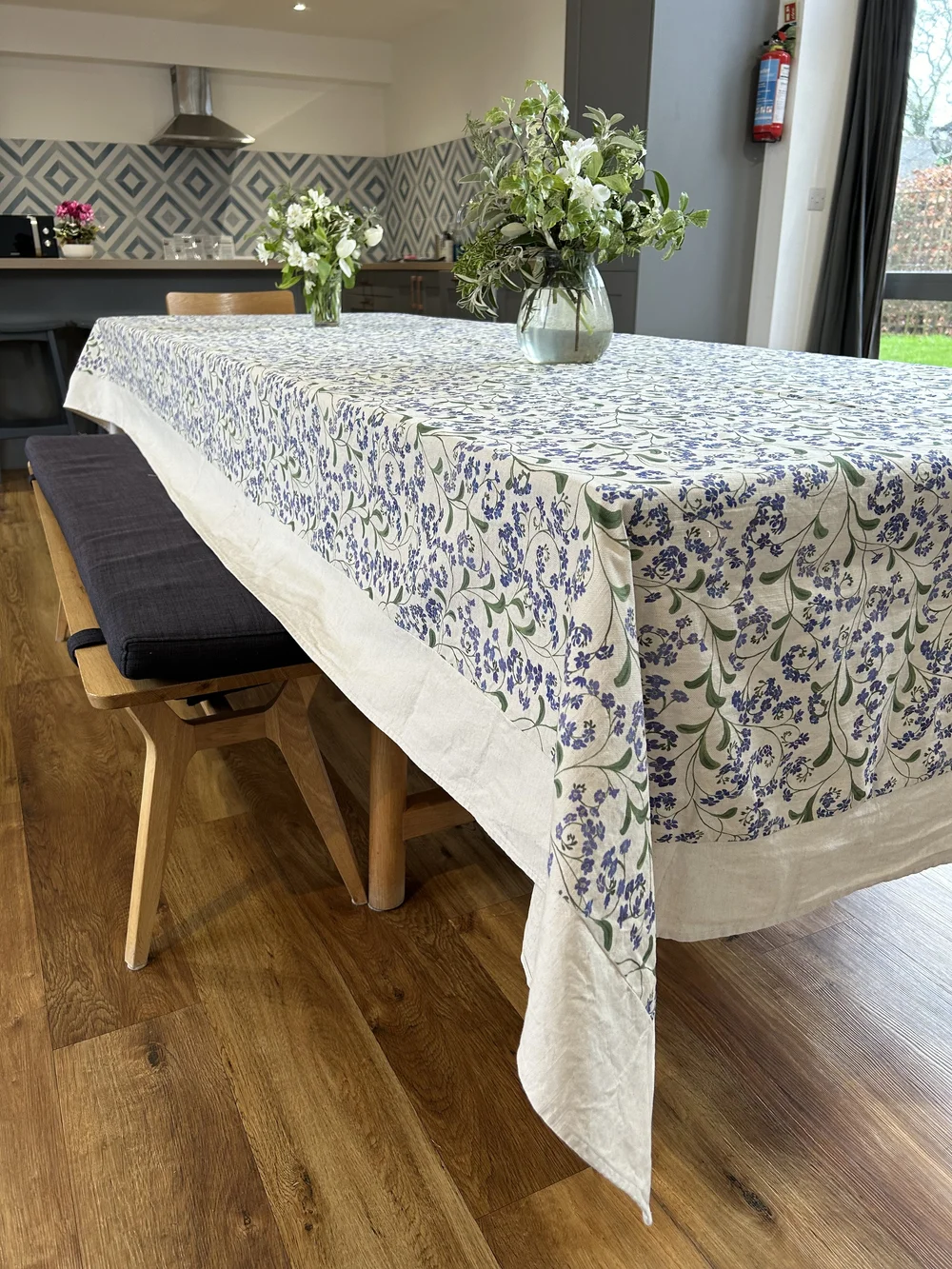 Extra wide forget me not floral linen tablecloth finished with mitred corners.  