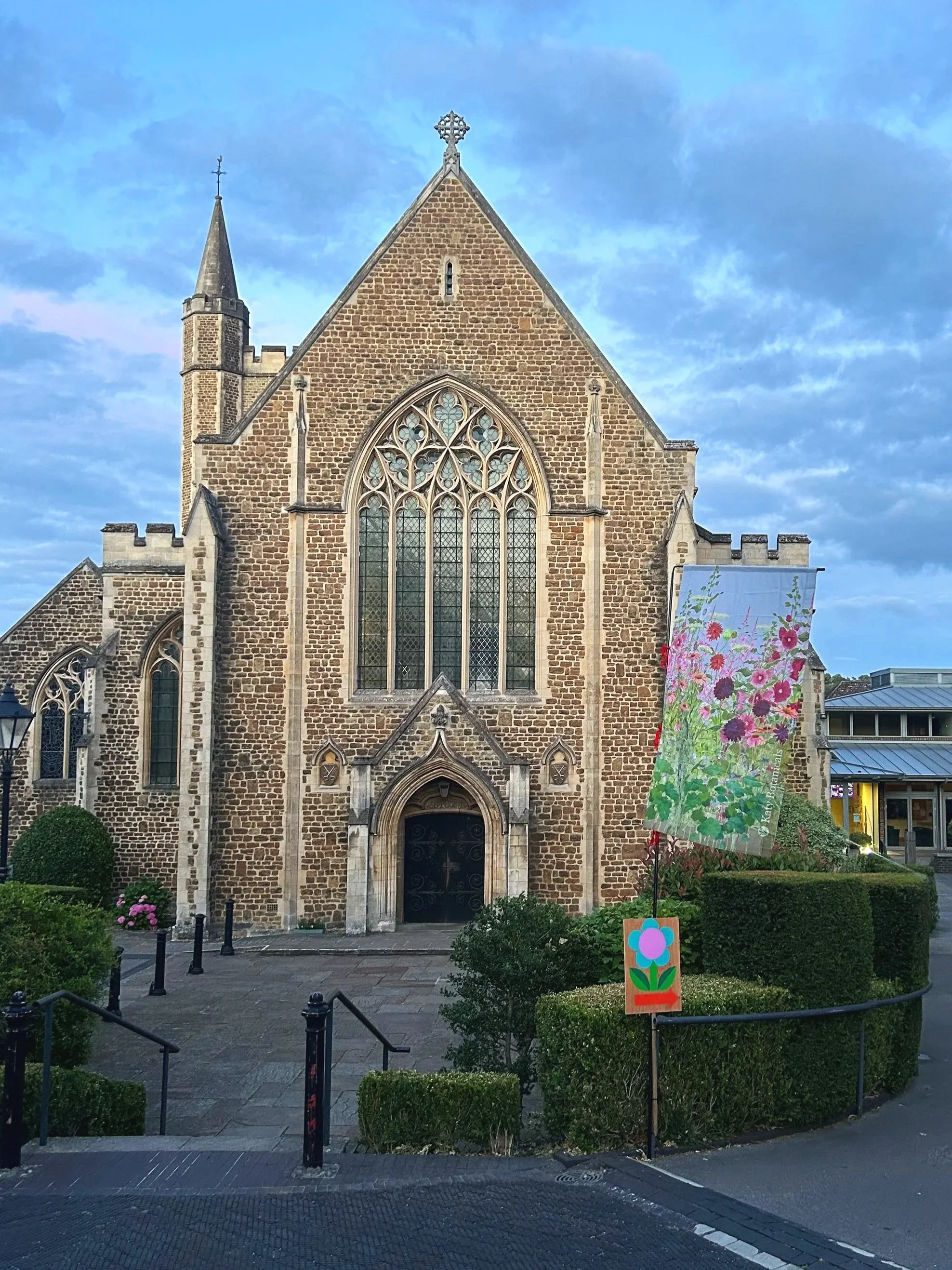Katy Botanicals floral flag being exhibited outside St Peter's Church, Winchester