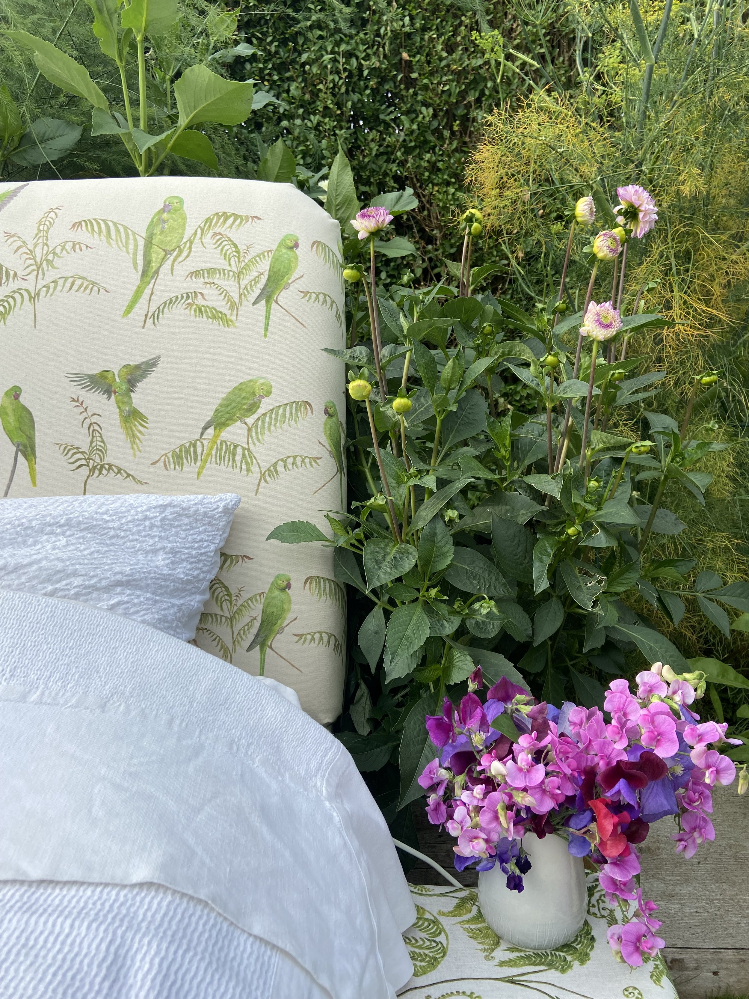 Linen headboard displaying a rose ringed parakeet design hand painted for Katy Botanicals