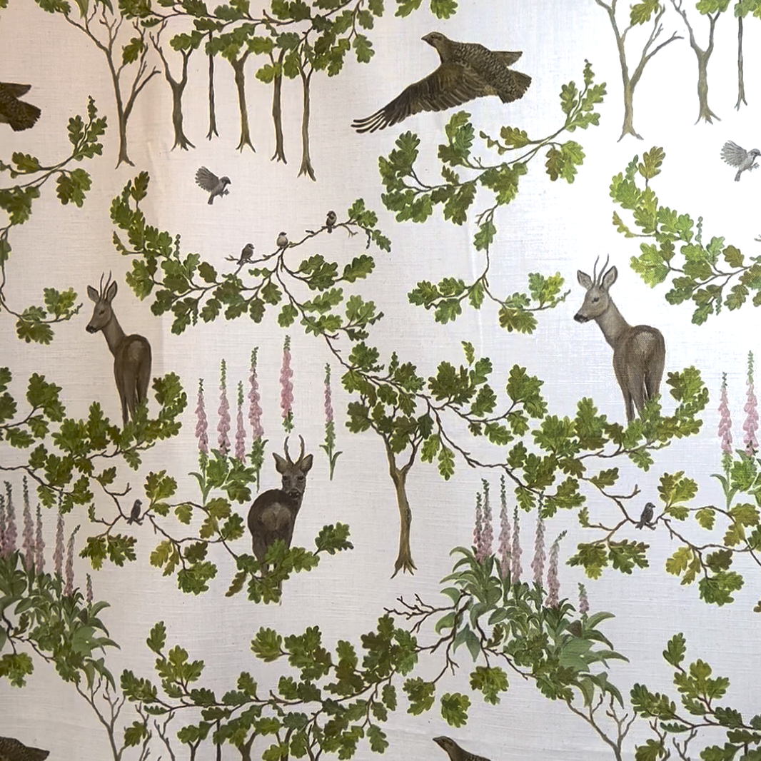 Nursery fabric featuring a woodland filled with deer and birds
