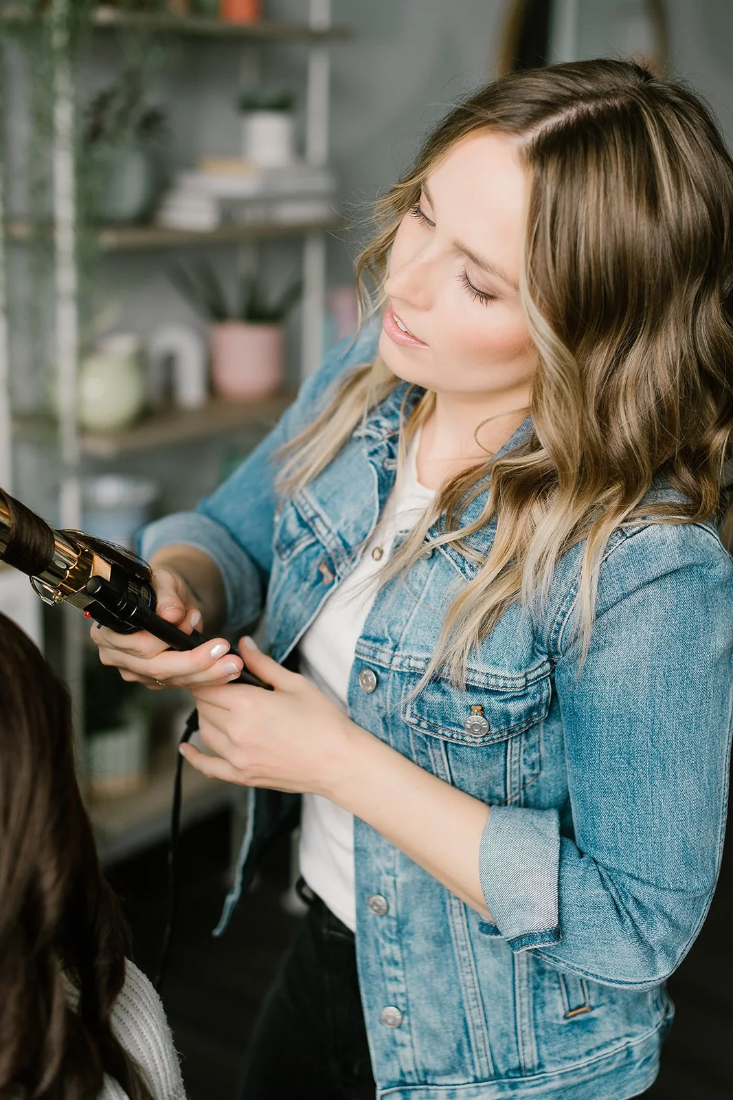 Teddi Bickers styling a women’s haircut in her private Carmel, IN hair studio