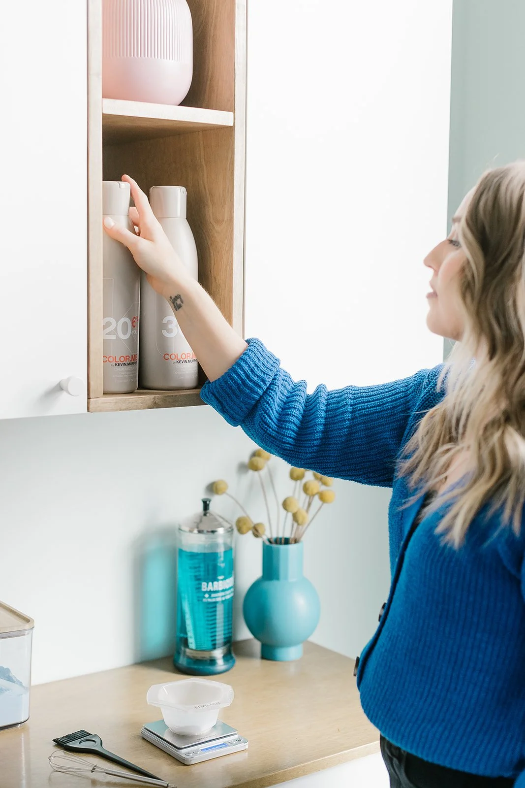 Teddi Bickers selecting hair color at her color bar in a private Carmel, IN hair studio.