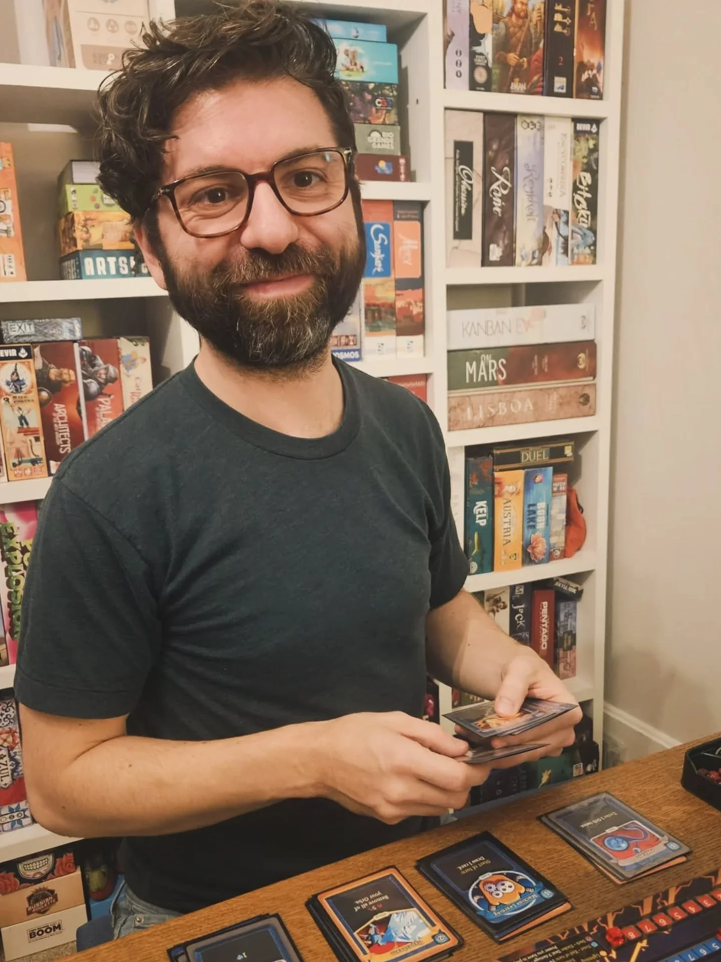 The Slay the Spire board game is pretty darn good. Here's me smiling as I play it as proof! 

Like the game art? Don't forget to visit my website, I interviewed the artists to learn how the Slay the Spire art was created. They are a talented bunch!
 